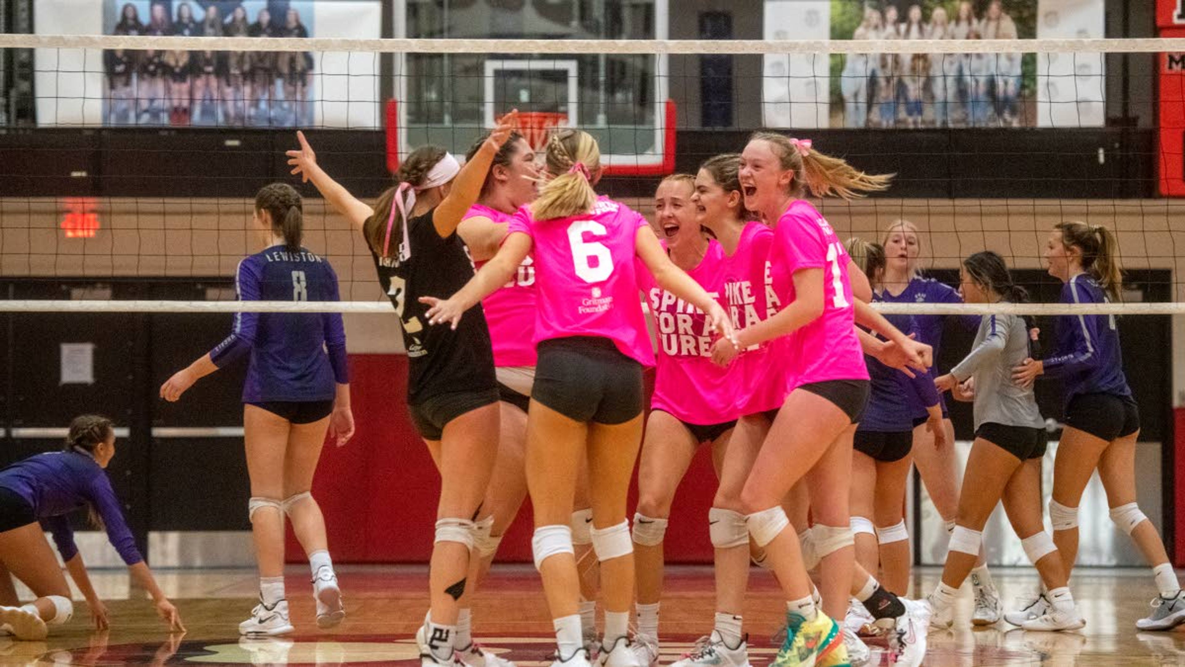 Moscow players celebrate after scoring a point during the third set of an Inland Empire League matchup Sept. 28 at Moscow Middle School.