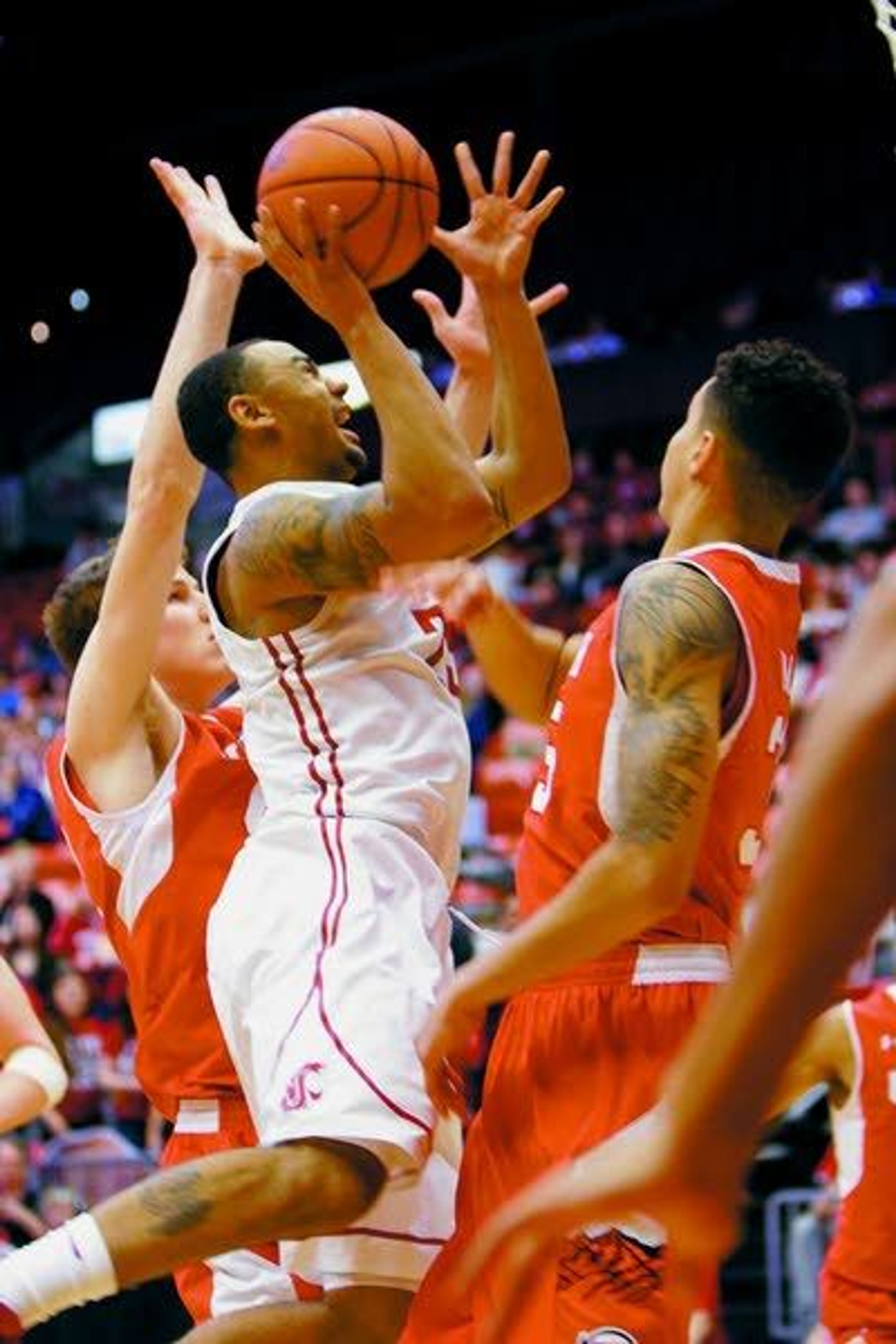 Washington State guard DaVonte Lacy shoots over Utah forward Kyle Kuzma during the first half Thursday in Pullman.