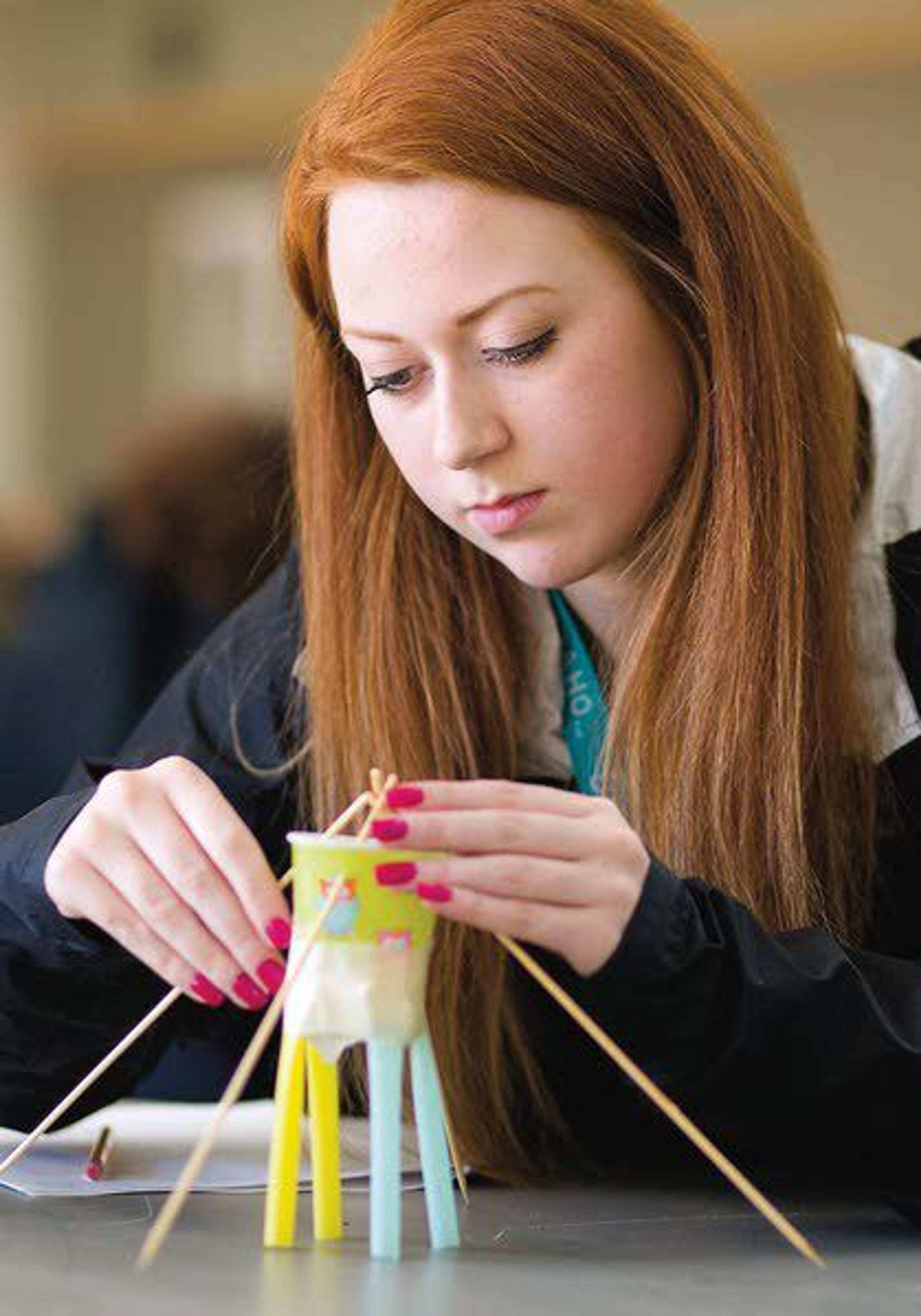 Holly Broughton from Mead High School works on her team’s payload delivery device as part of a design challenge during Women in Engineering Day on Friday at the University of Idaho in Moscow. Students designed devices to protect an egg in fall from about 25 feet.