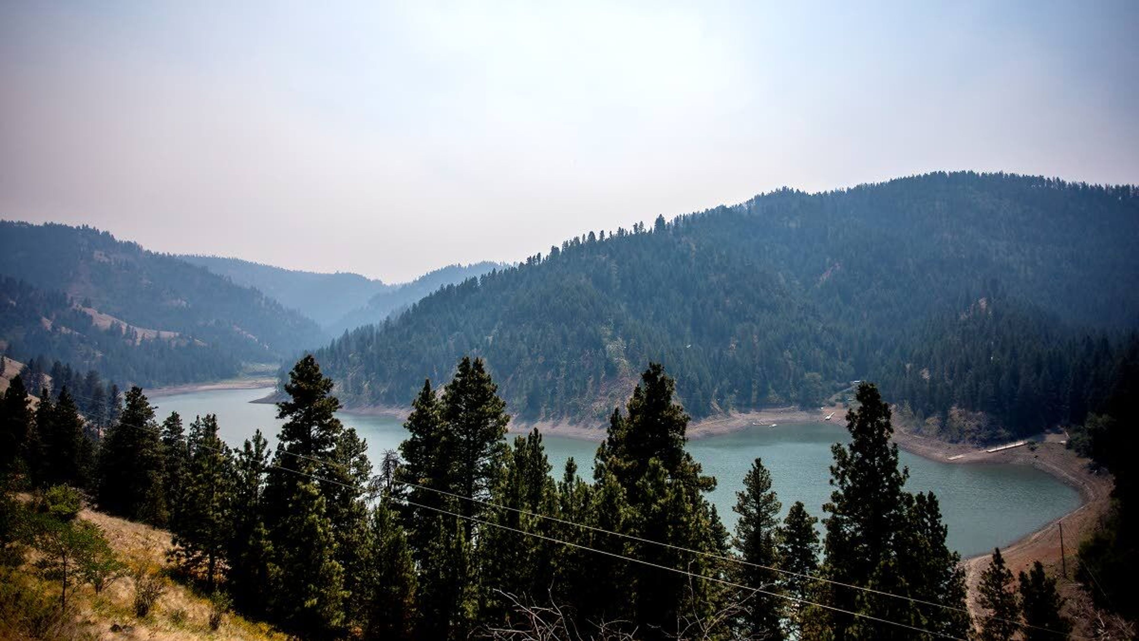 Smoke fills the air surrounding Lake Waha as firefighters continue to battle the Captain John Creek fire to the south.