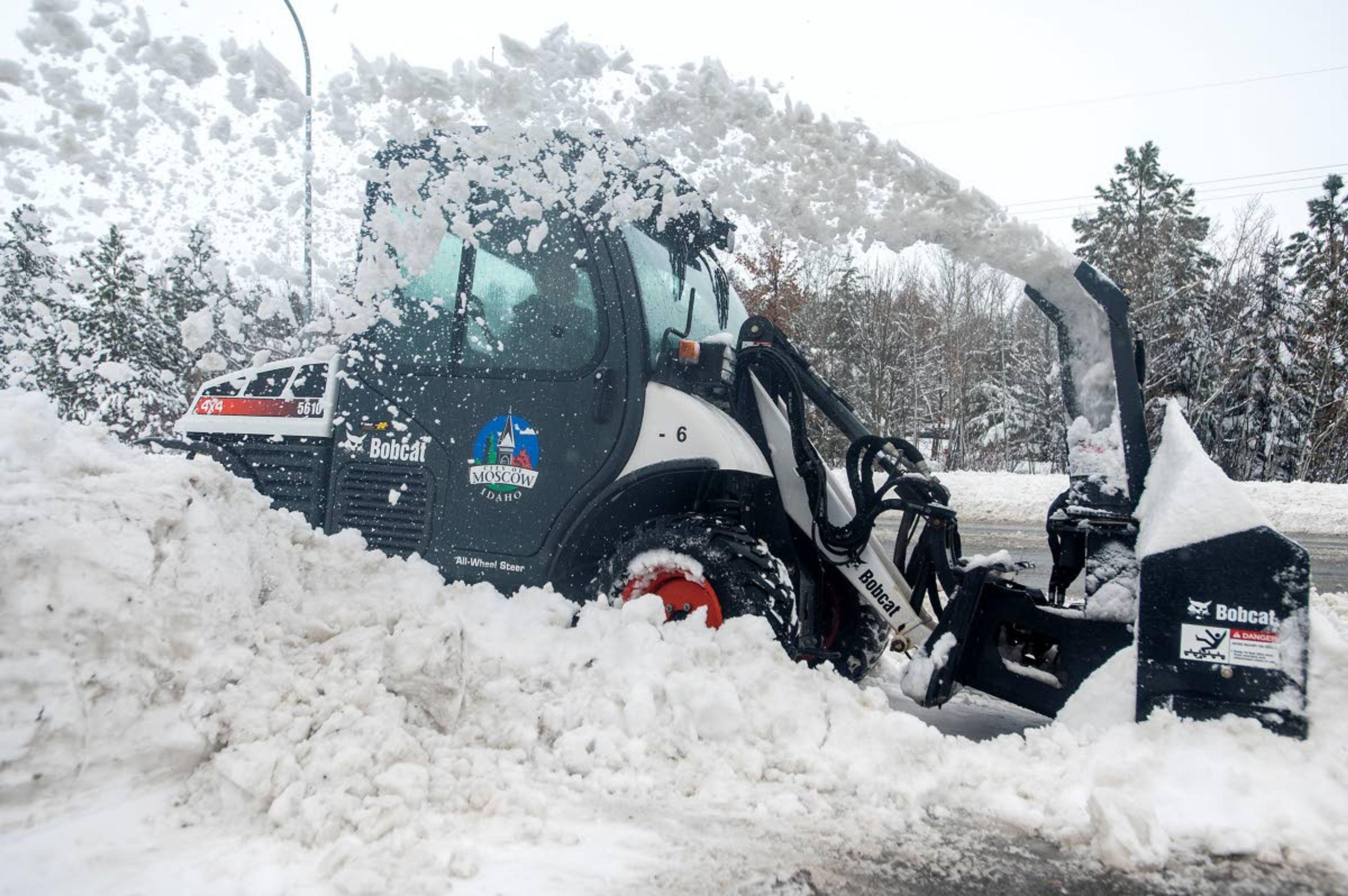 Roy Bremenour clears snow from the sidewalk along State Highway 8 on Thursday afternoon in Moscow.