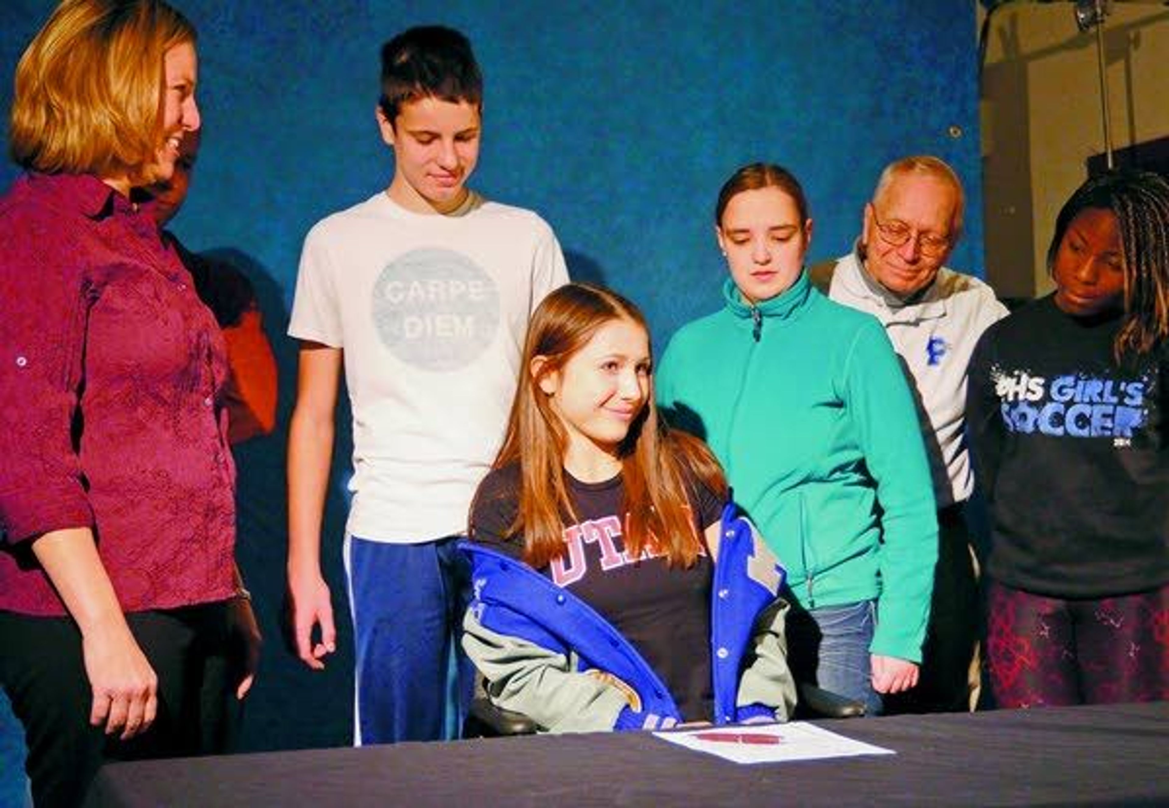 This Nov. 20, 2014, file photo shows Lauren McCluskey as she removed her Pullman High School jacket to reveal a University of Utah T-shirt. McCluskey signed a letter of intent to compete in track for the University of Utah.