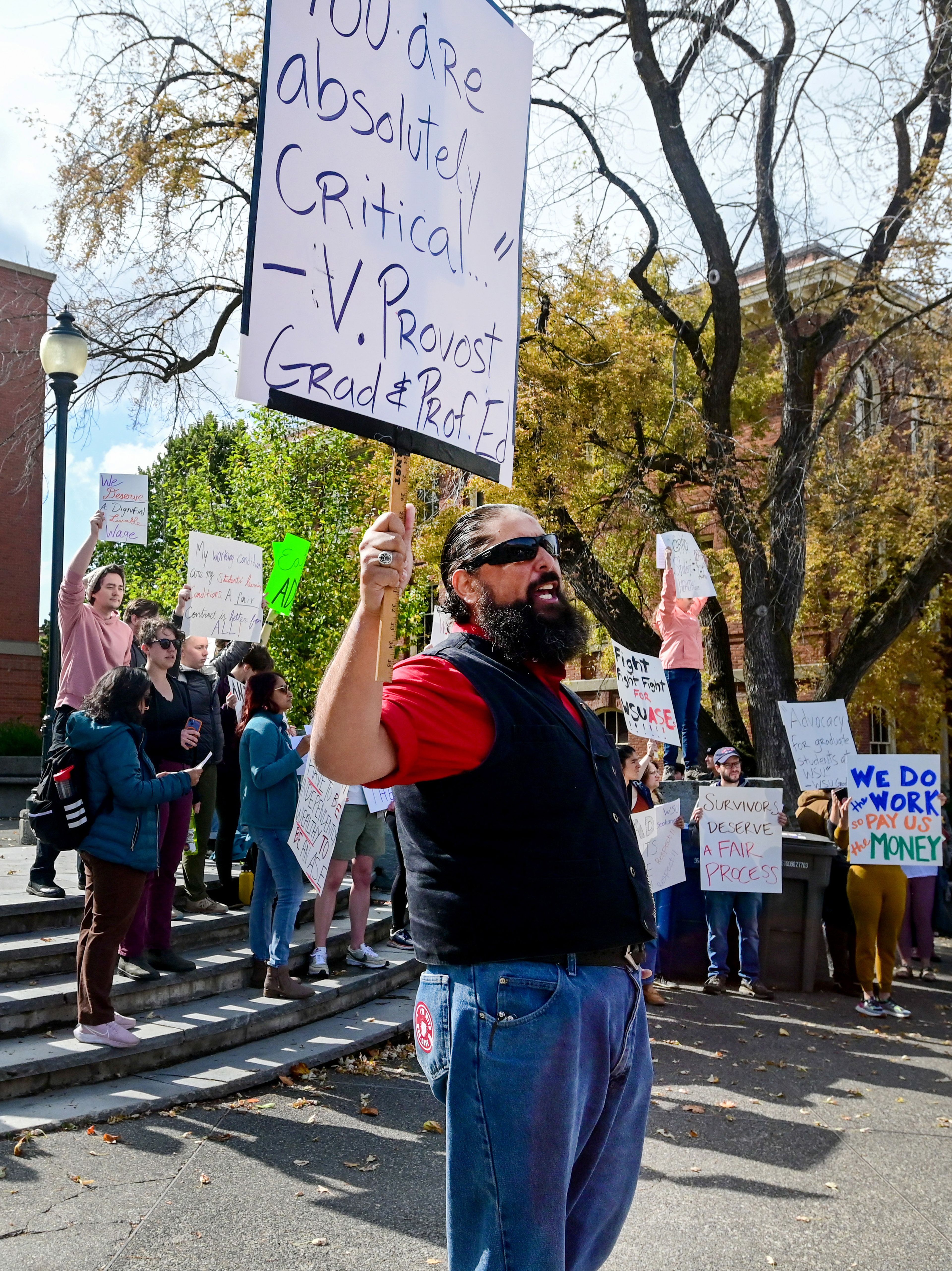 Eloy Trujillo, a masters student in rhetoric and composition studies at Washington State University, leads a chant at a rally supporting contract negotiations for Academic Student Employees at Glenn Terrell Mall on Wednesday in Pullman.