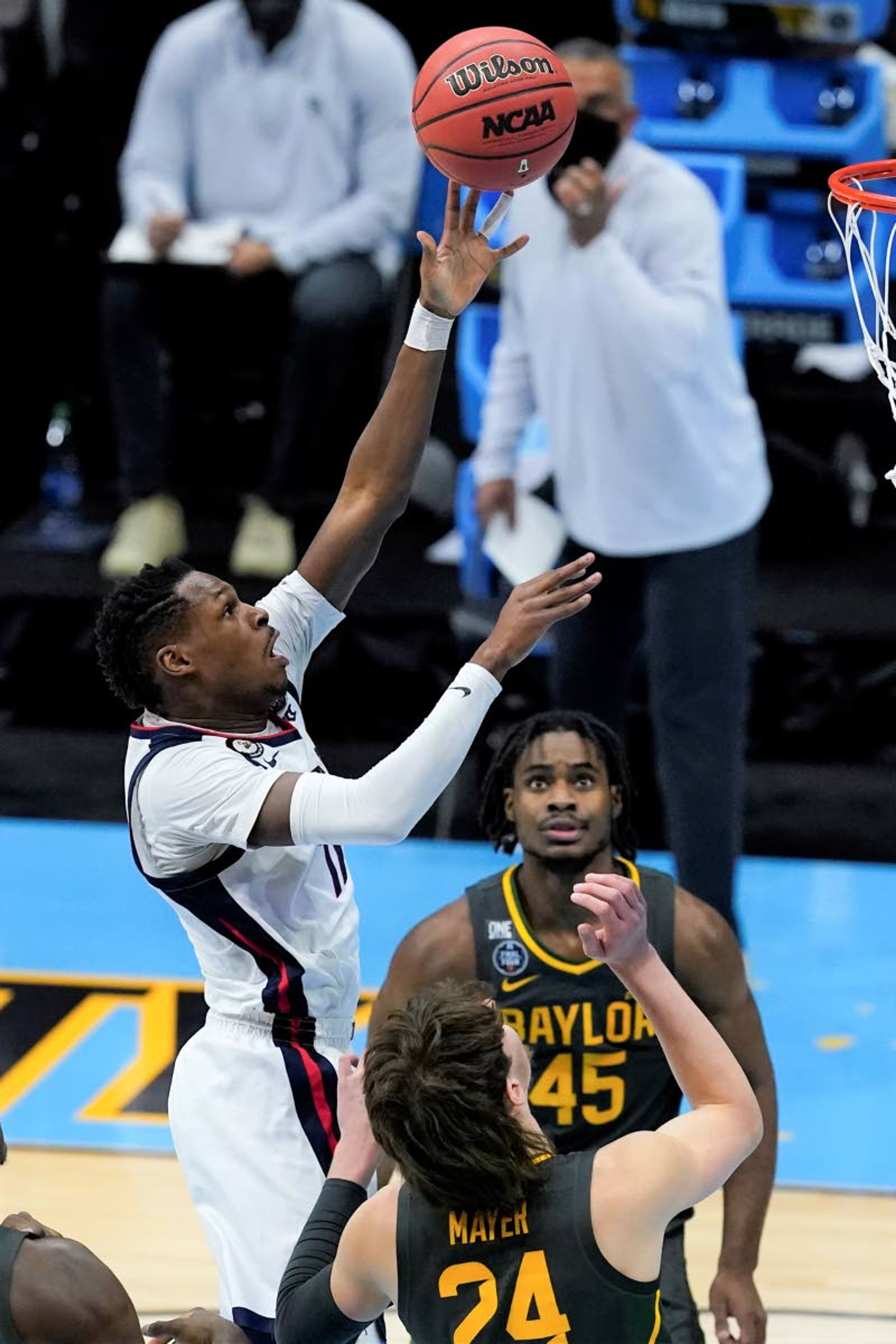 Gonzaga guard Joel Ayayi, left, shoots over Baylor guard Matthew Mayer (24) and guard Davion Mitchell (45) during the first half of the championship game in the men's Final Four NCAA college basketball tournament, Monday, April 5, 2021, at Lucas Oil Stadium in Indianapolis. (AP Photo/Darron Cummings)