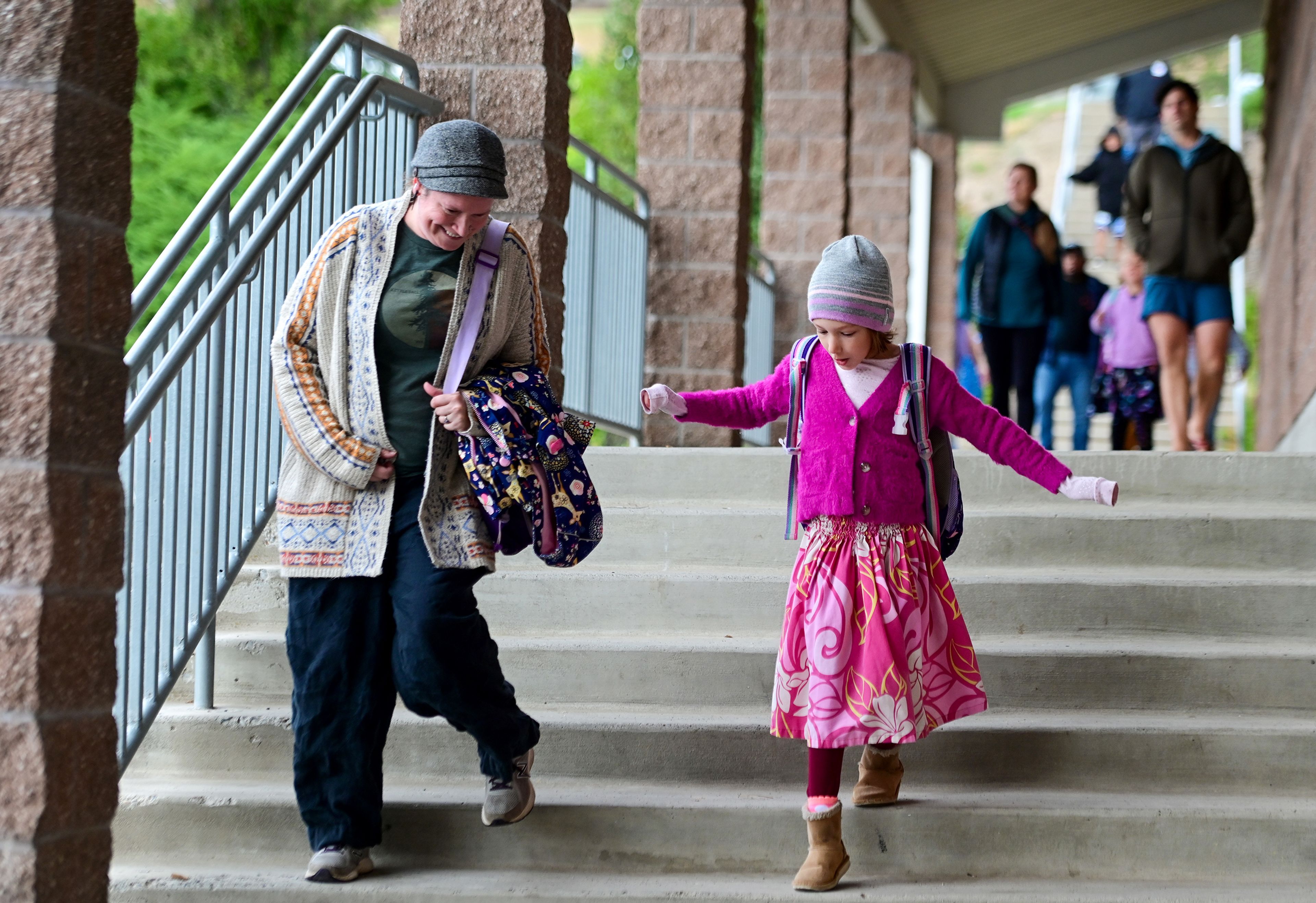 Nymeria Aufdemberg, right, is walked down the stairs of Jefferson Elementary School for the first day of third grade on Wednesday in Pullman.