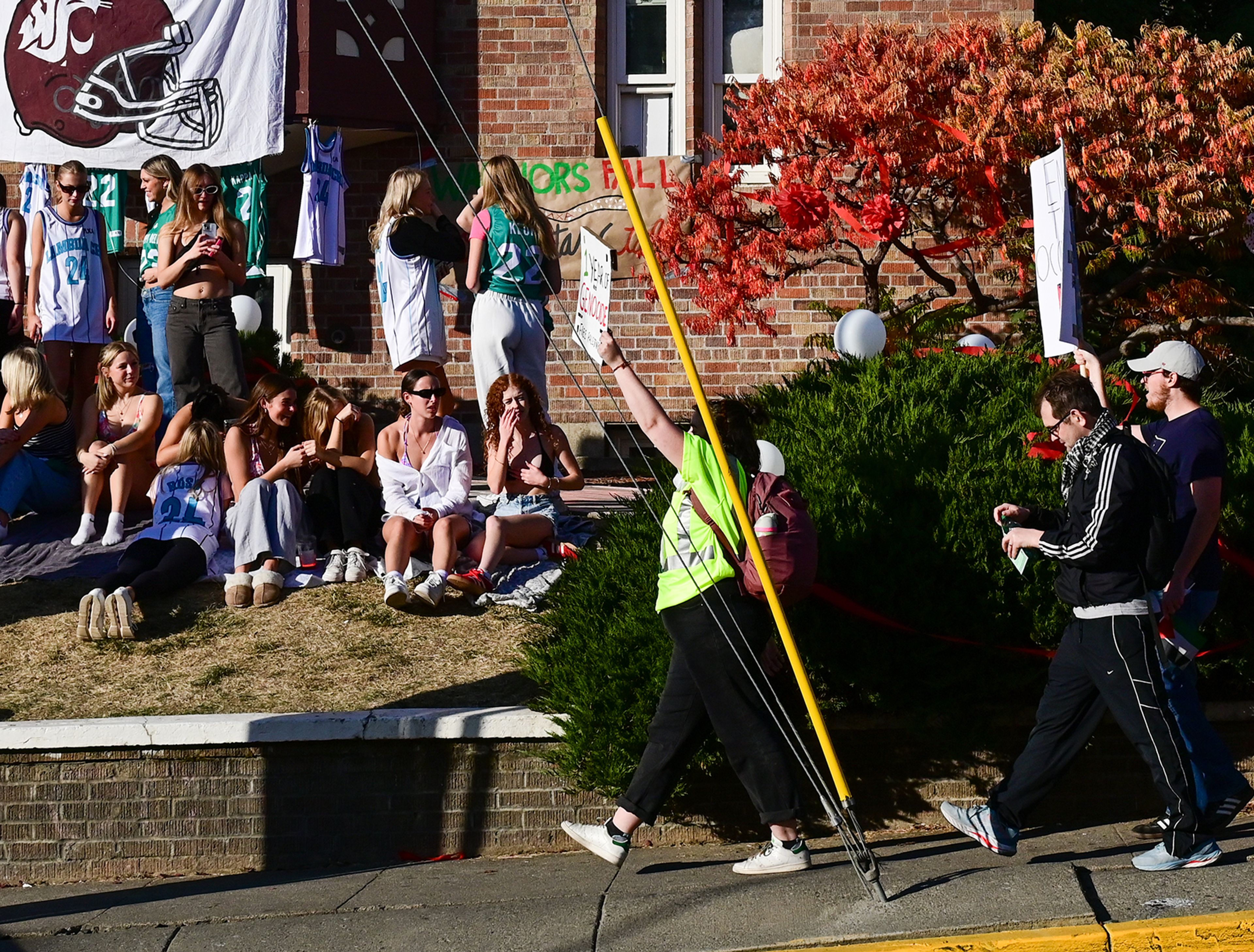 A group marching in Palestinian solidarity passes by fraternity events as they head toward downtown from campus Monday in Pullman.,