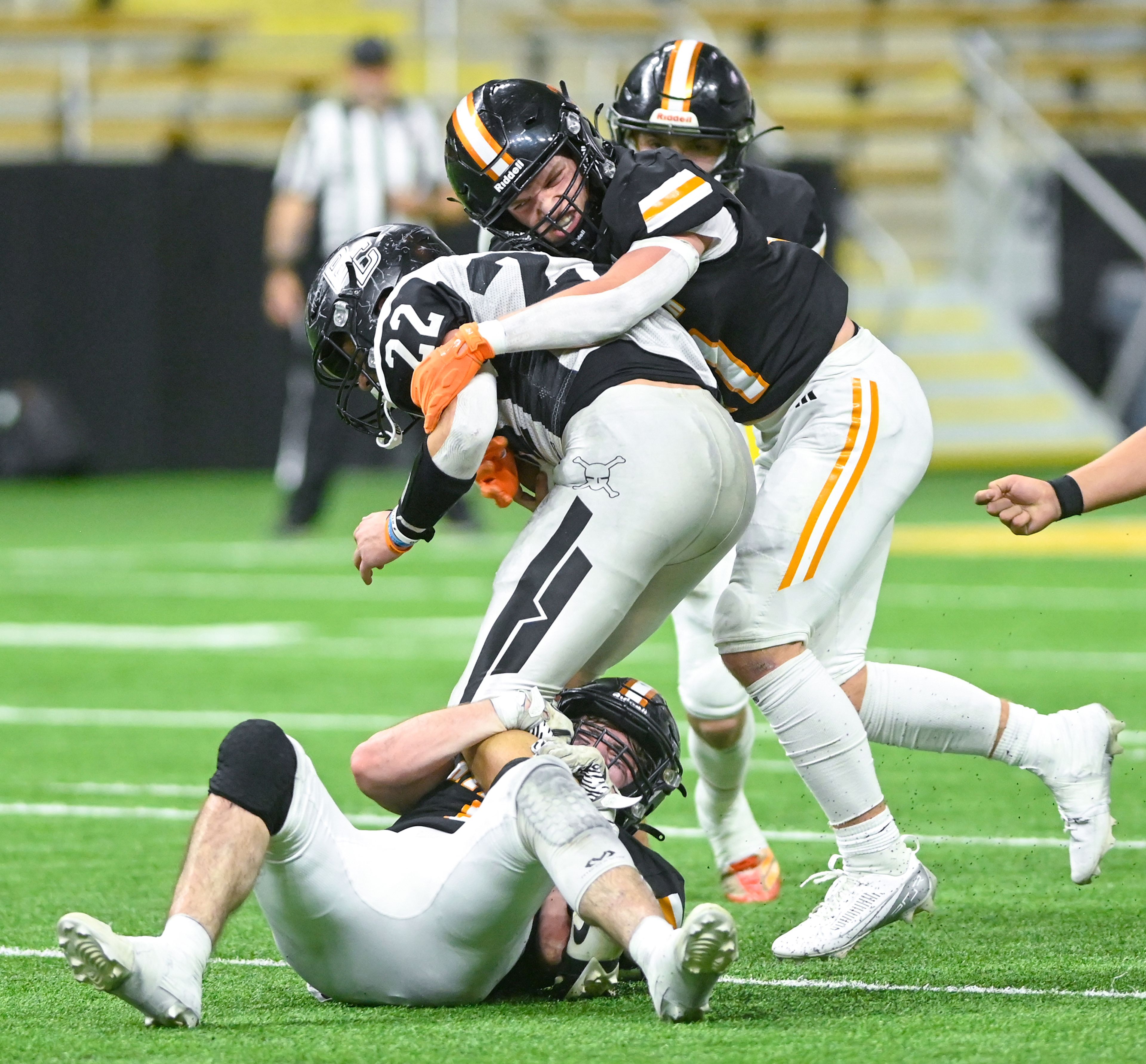 Kendrick defenders including Nathan Kimberling, right, tackle Butte County’s Razor Duke Friday during the Idaho 2A football state championship game at the P1FCU Kibbie Dome in Moscow.