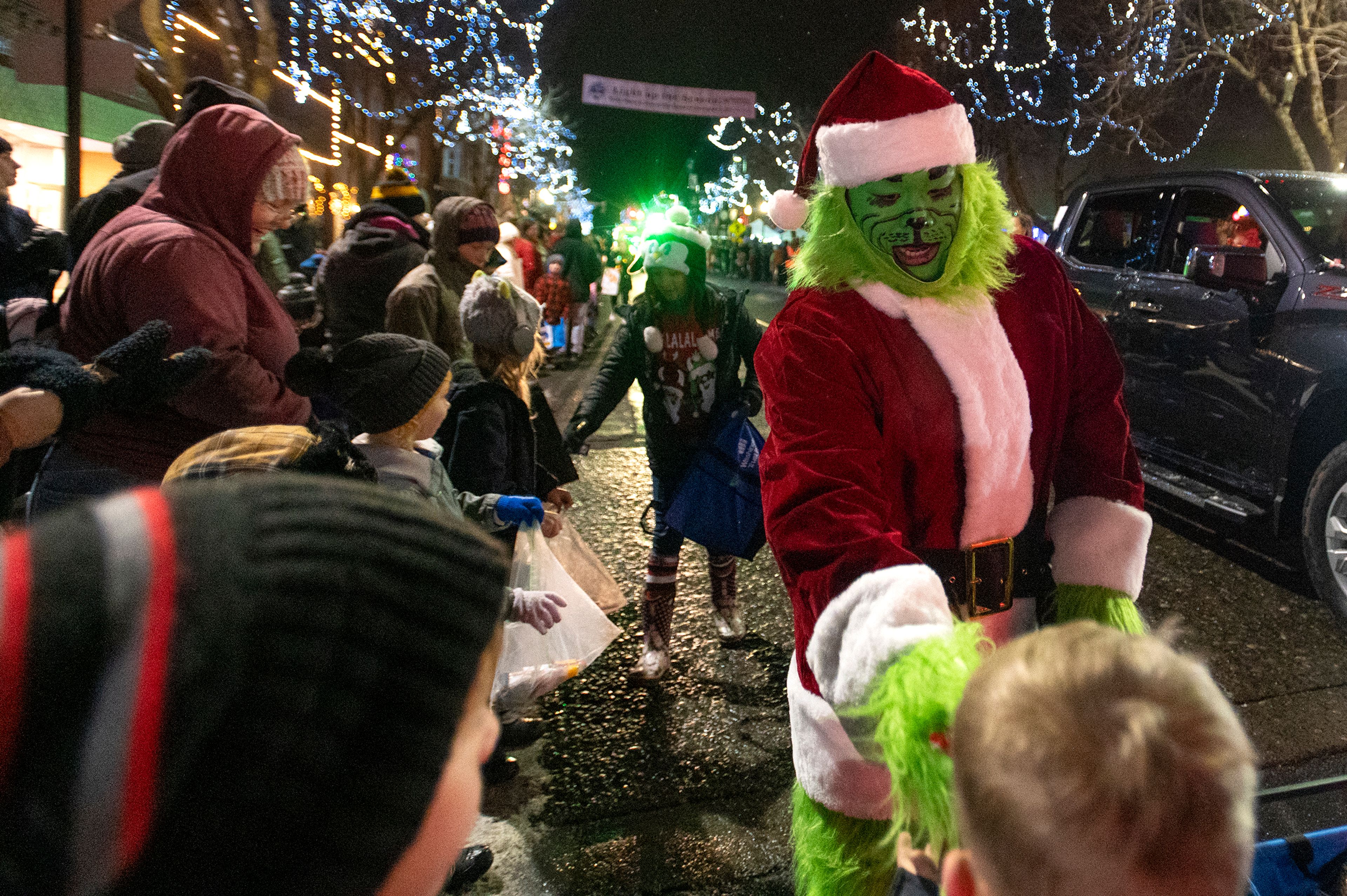 The Grinch hands out candy during the Light up the Season Parade in downtown Moscow on Thursday.