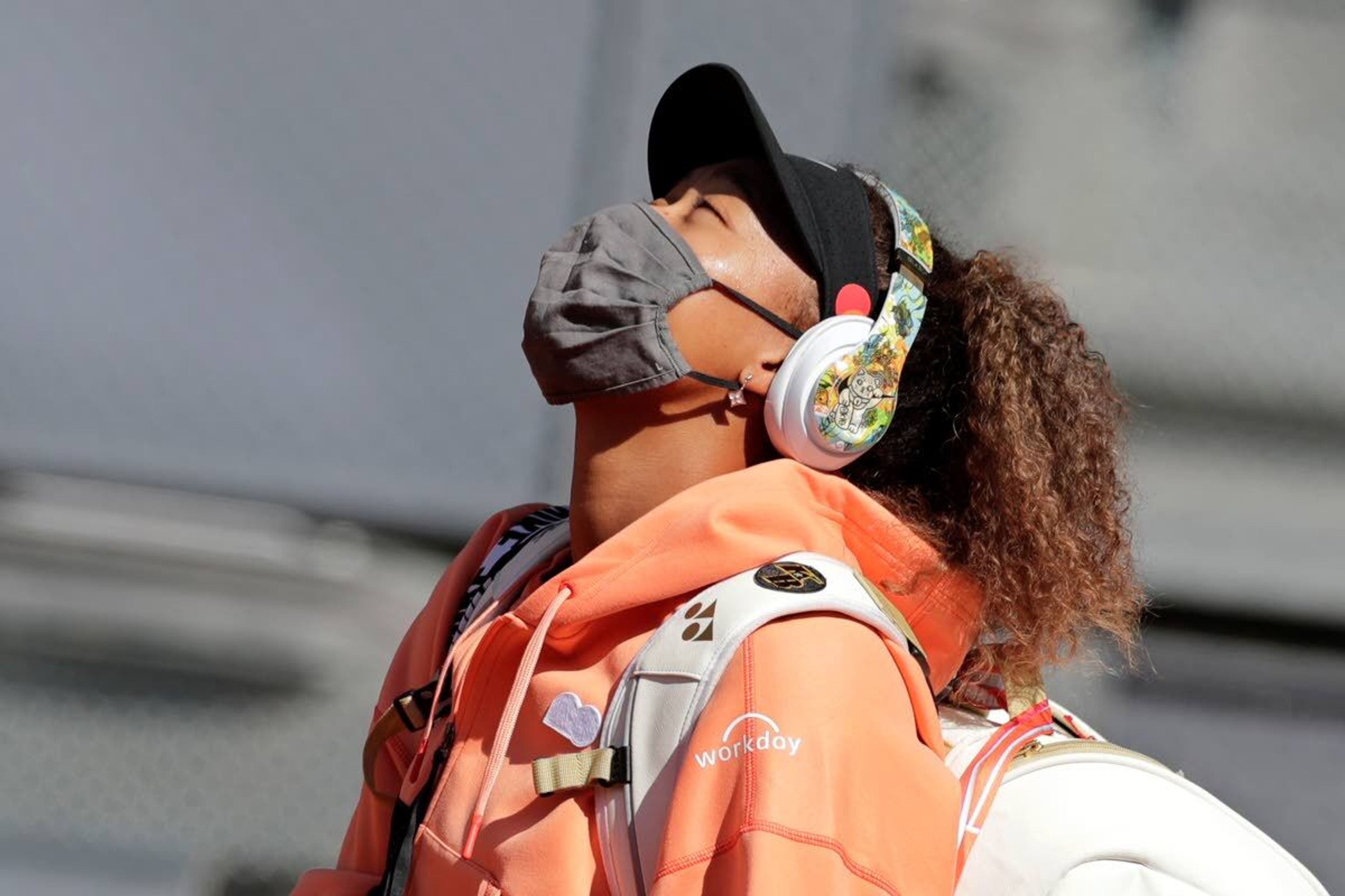 Naomi Osaka of Japan arrives on court for her match against Karolina Muchova of the Czech Republic during their match at the Madrid Open tennis tournament in Madrid, Spain, Sunday, May 2, 2021. (AP Photo/Paul White)