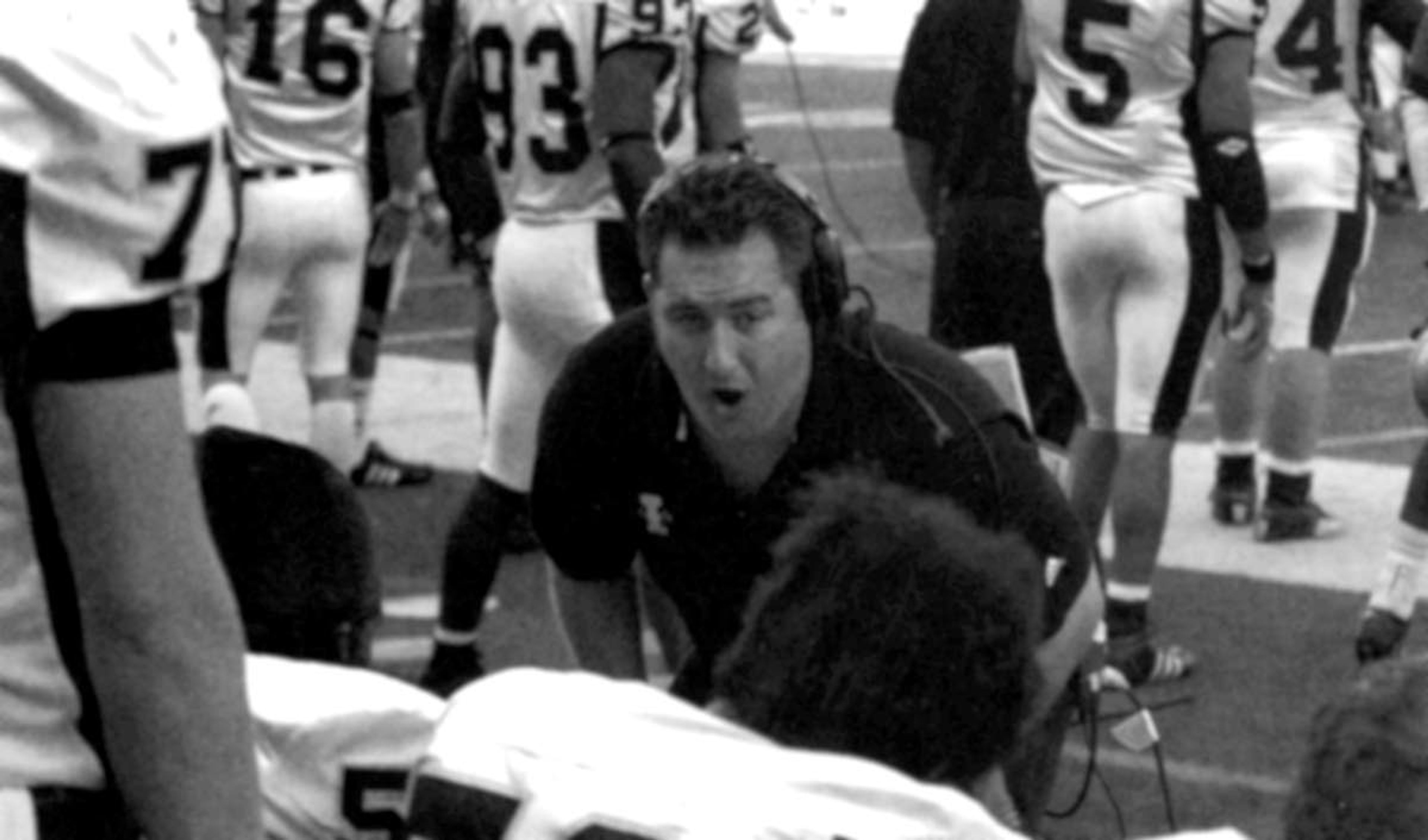 Jason Eck coaches Idaho offensive linemen on the sidelines in a game during the 2004 season.