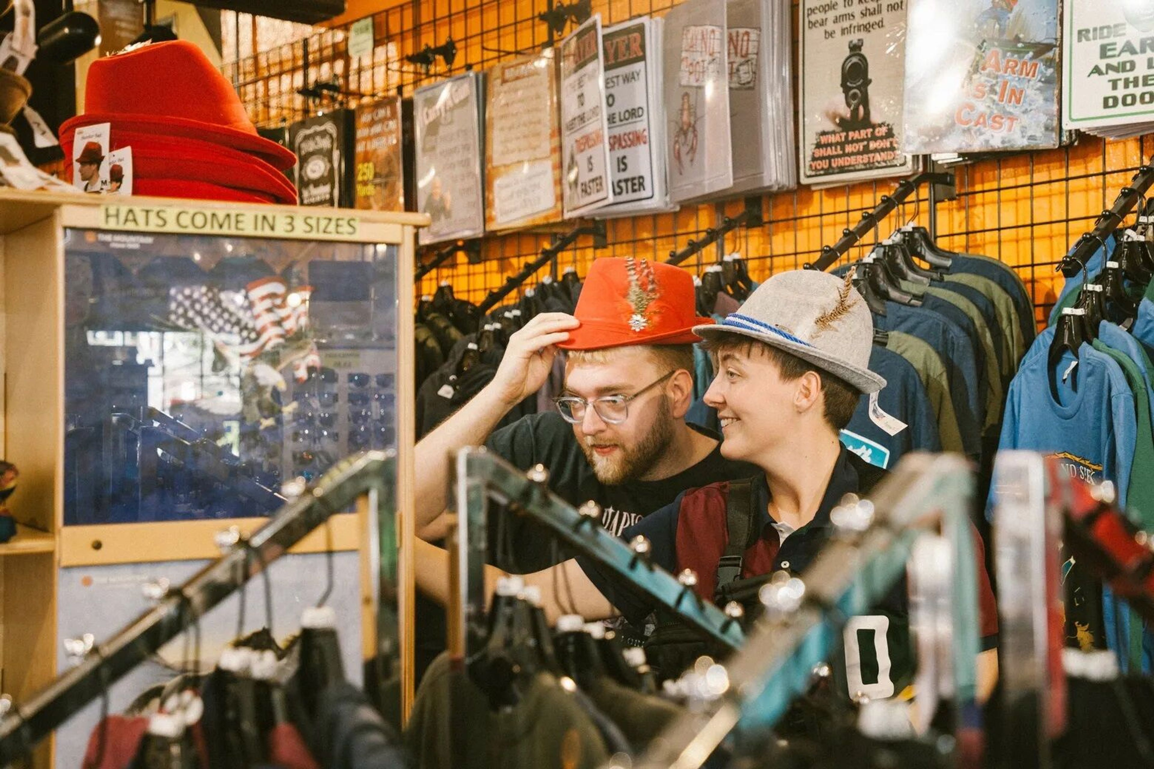 Visiting journalists Max Tenschert and Antonia Titze try on Alpine hats in a souvenir shop in Leavenworth, Chelan County.