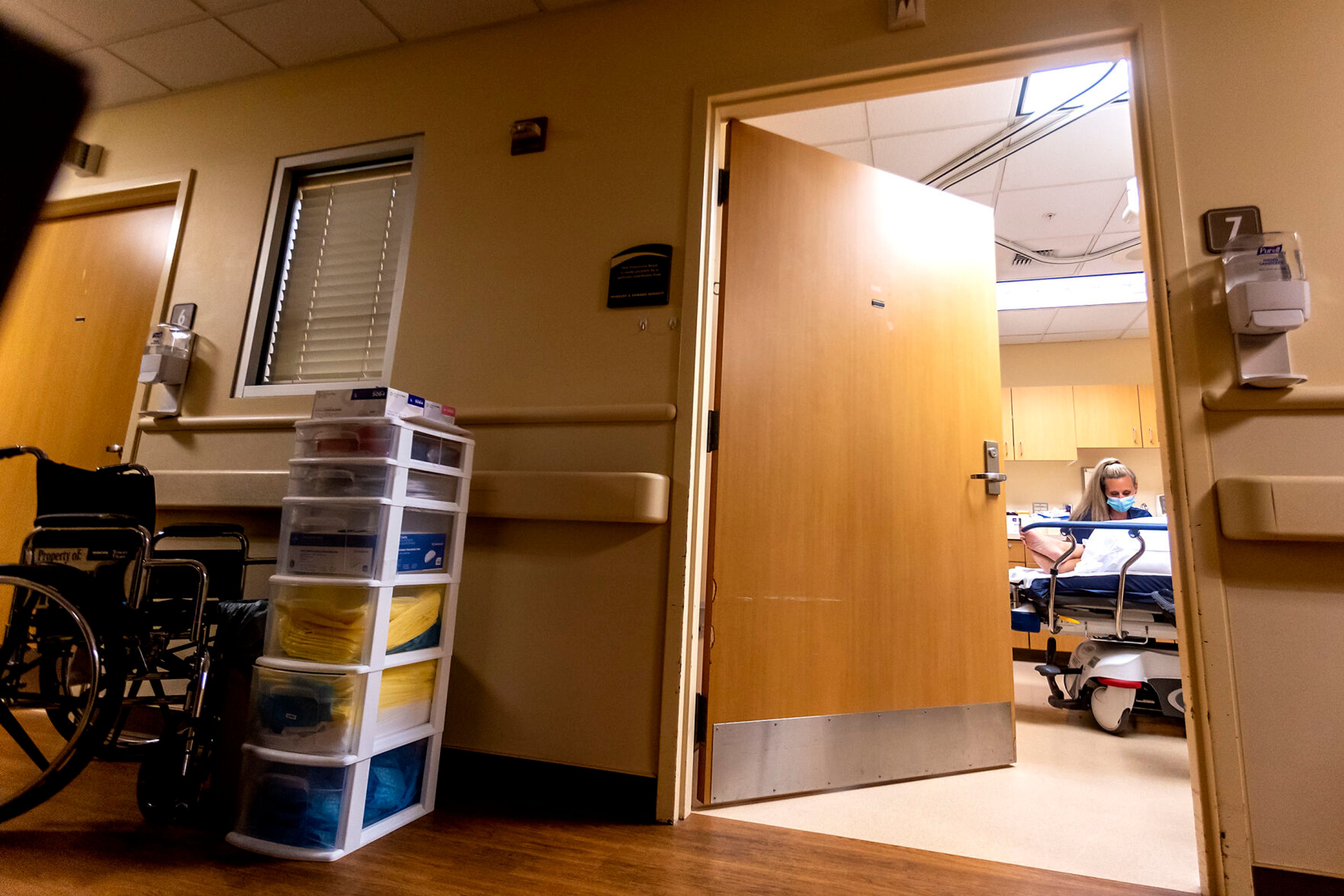 Kelsey Erwin talks with a patient while sitting next to her bed at the Pullman Regional Hospital emergency room Sept. 24.