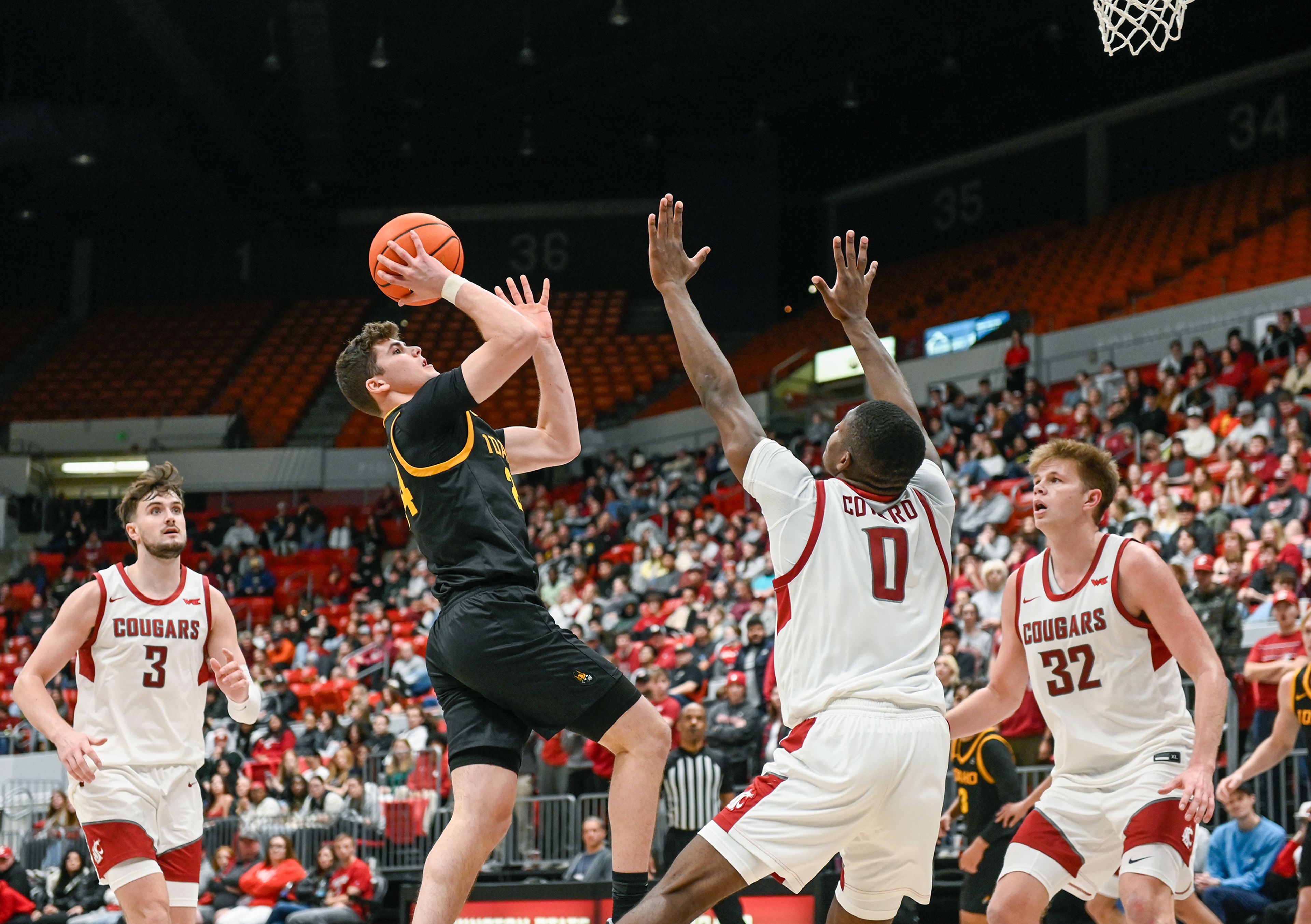 Idaho guard Miles Klapper attempts a two-point shot with pressure from Washington State guard Cedric Coward Monday during the Battle of the Palouse game at Beasley Coliseum in Pullman.