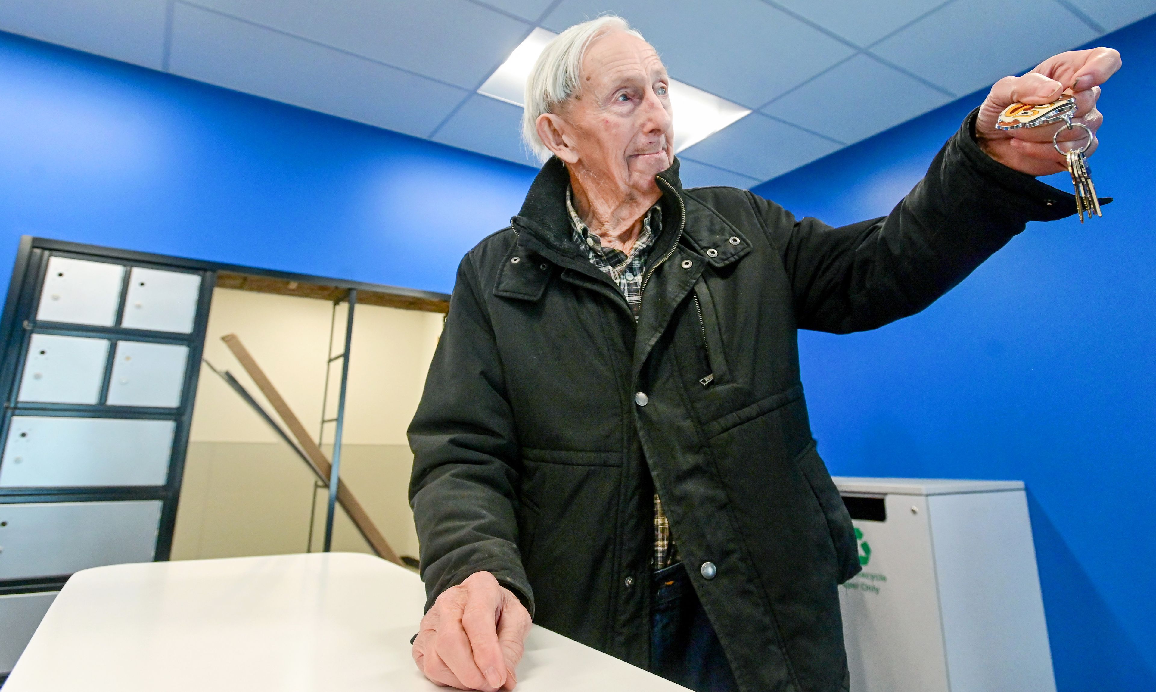 Jim Jacobs, a resident of Malden for nearly three decades, holds up his keychain after adding the first Malden mailbox key to it on Thursday. Postmaster Trina Robinson presented Jacobs with the key after the ribbon cutting for the town’s new facilities.