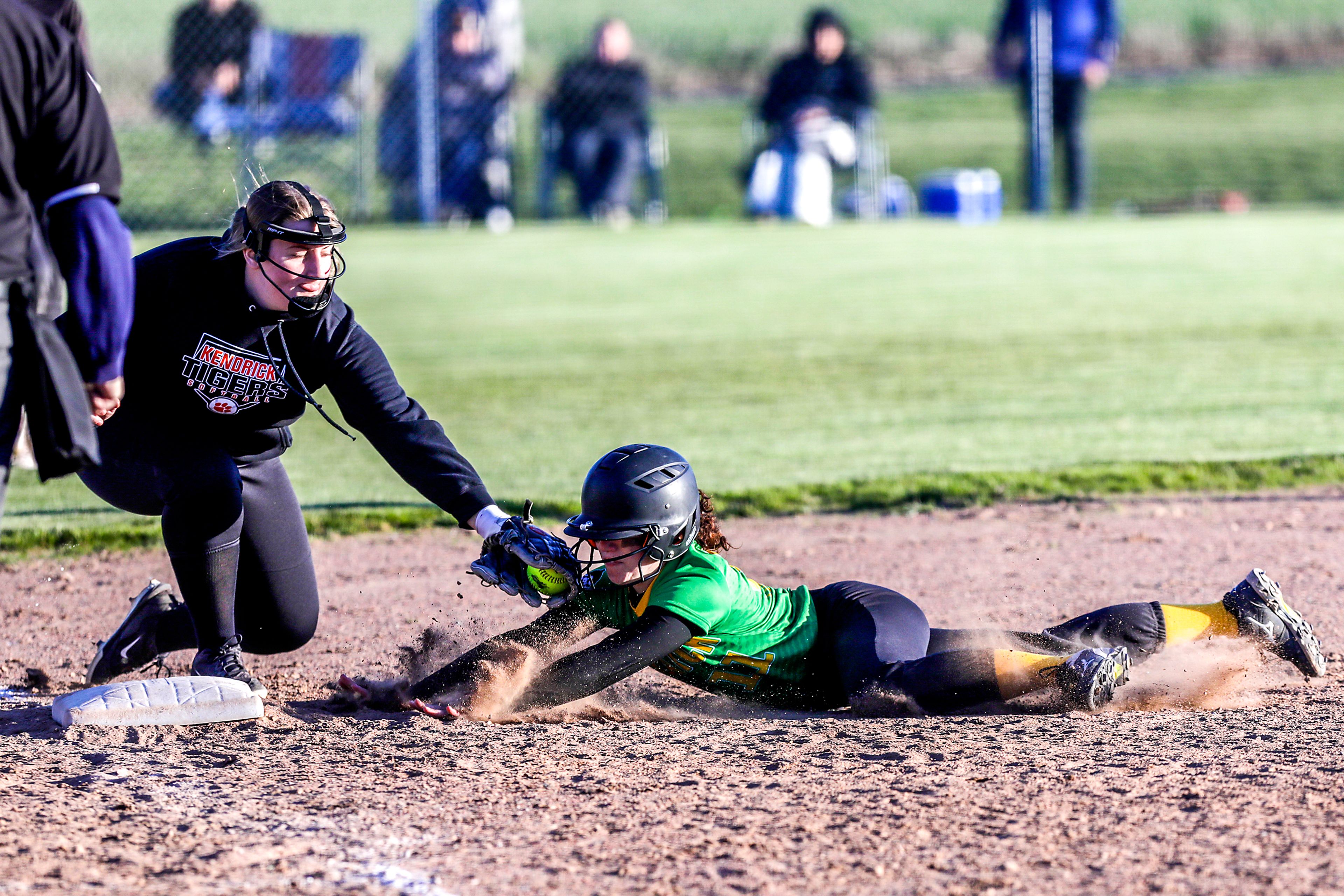 Kendrick High third baseman Hannah Tweit tags out Potlatch’s Delaney Beckner as she slides into third base.