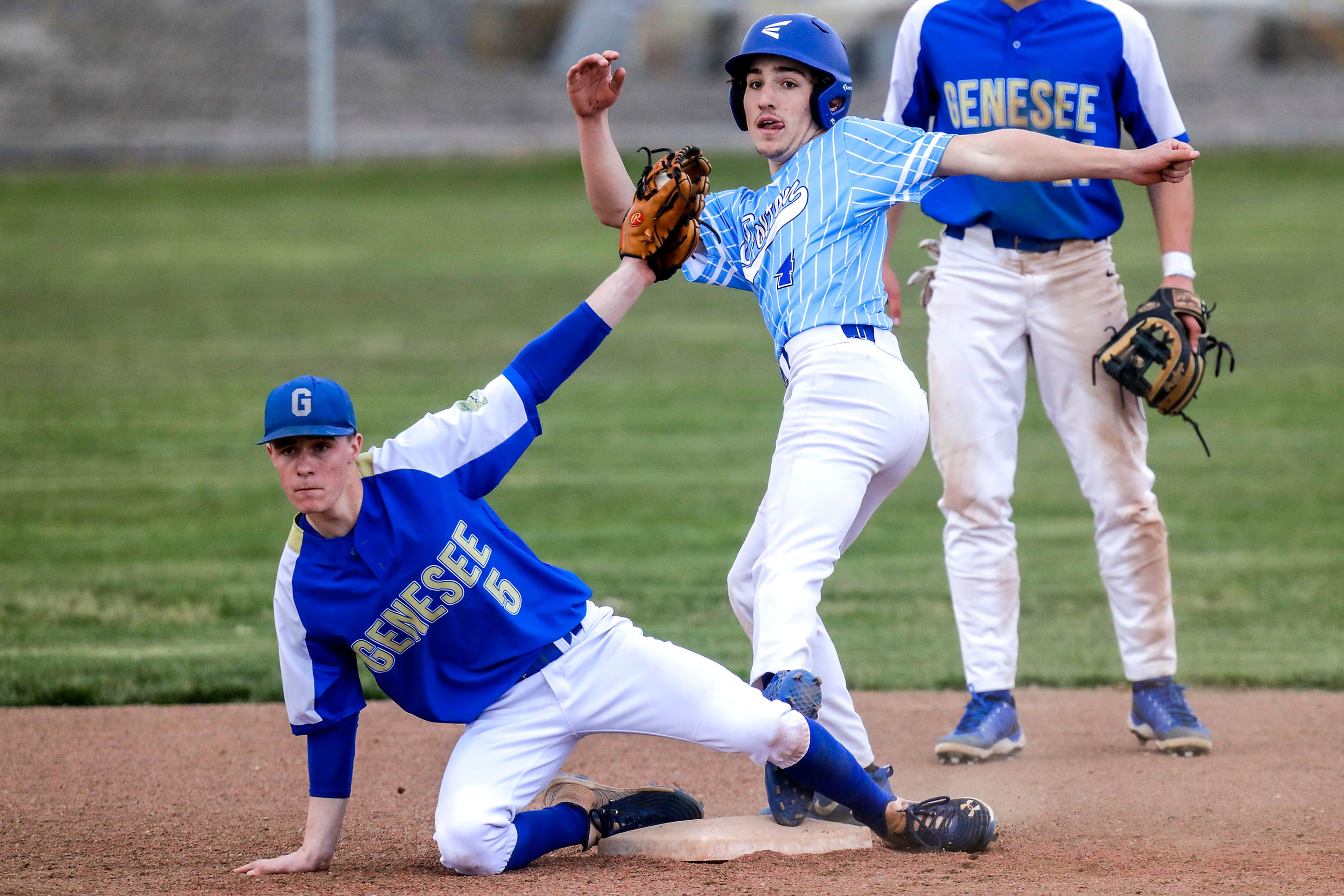 Genesee Teak Wareham and Colton Angus Jordan look up to see if Jordan got onto second base in Genesee on Monday. Jordan was declared safe.