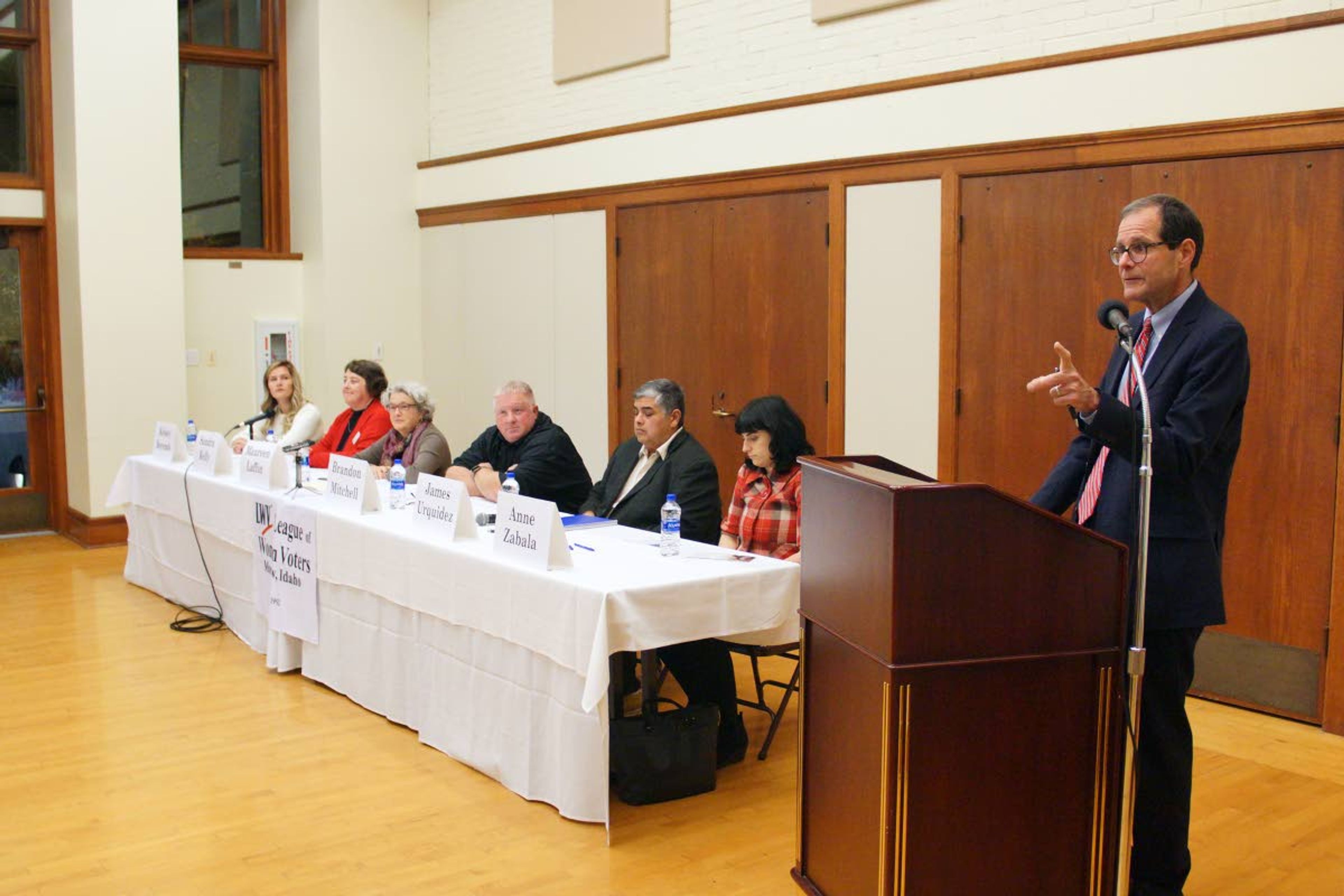 Moderator Richard Seamon, standing, explains the process of giving the city council candidates questions at the beginning of a League of Women Voters candidate's forum in the Great Room of the 1912 Center on Wednesday night.