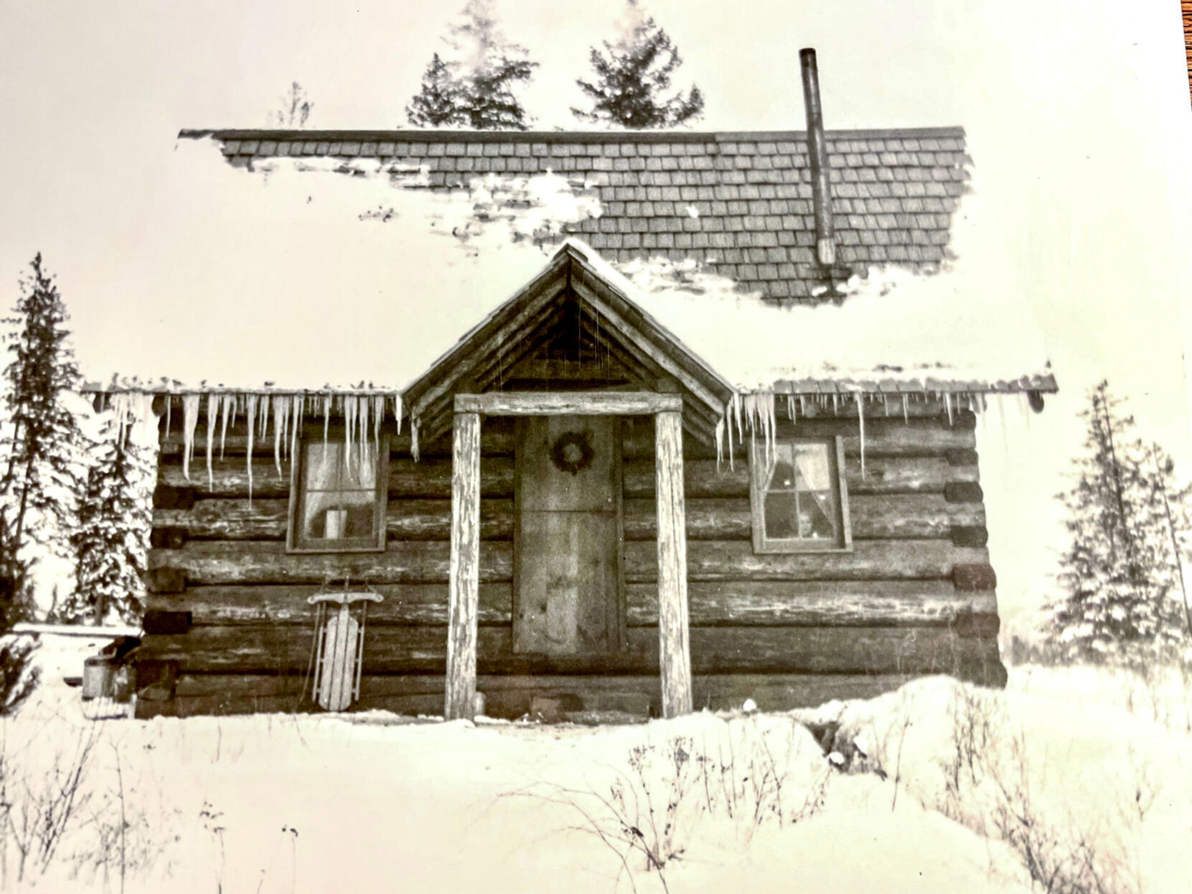 The Bulls' cabin along Hatter Creek is shown in winter. The face of their son, Stanley Stater, is visible peering from the window at right. (Andy Bull collection)