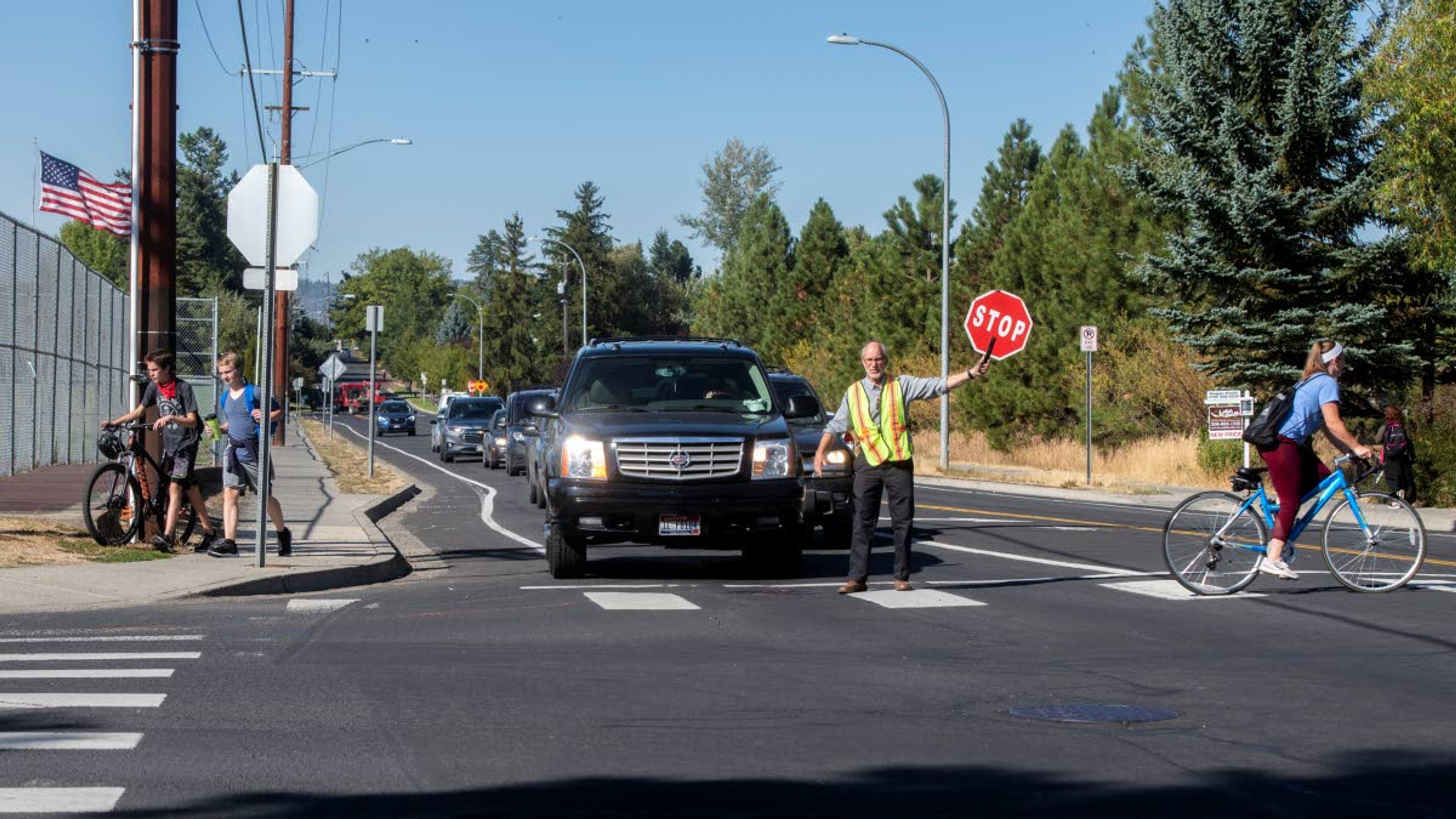 Charlie Gerke helps young students cross the intersection of D Street and Mountain View Road as traffic begins to pile up Tuesday afternoon in Moscow. When asked about the daily surge of traffic at the intersection, Gerke said, “There’s too many cars going in too many directions. We’ve all had close calls.”