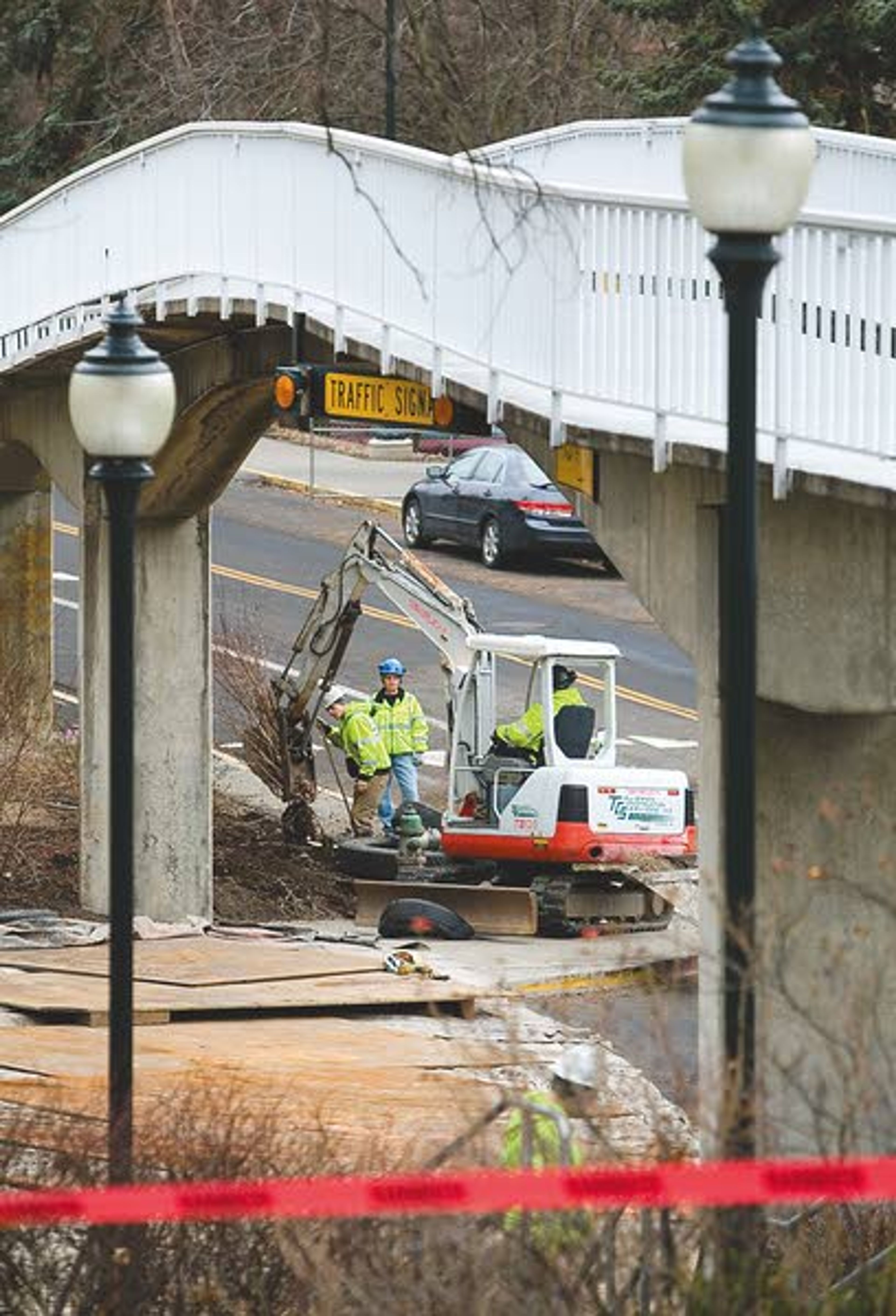 Workers from Talisman Construction Services prepare to remove an old pedestrian bridge at the intersection of Stadium Way and Nevada Street in Pullman on Saturday. The bridge is being removed because it is no longer structurally sound.