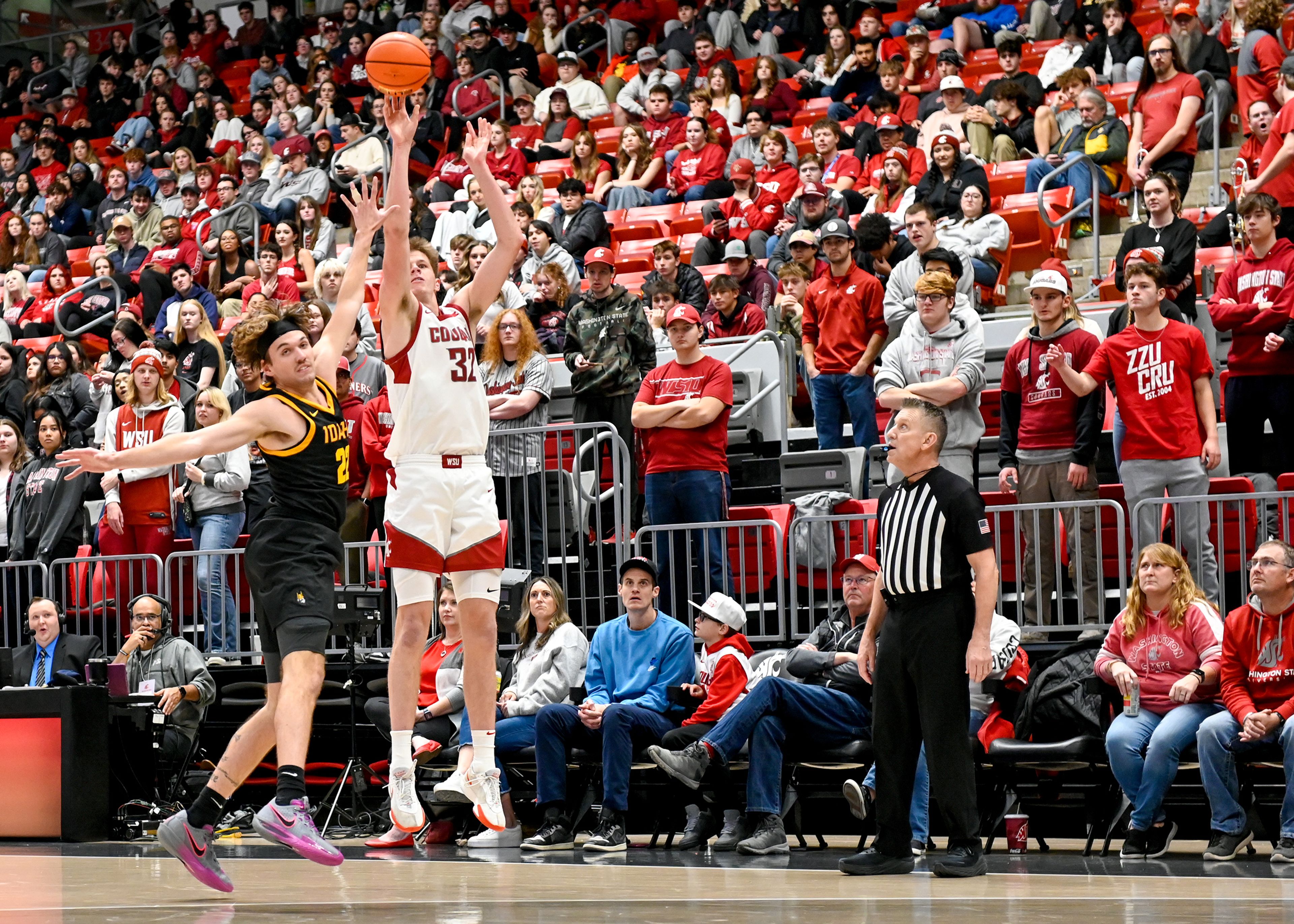 Idaho forward Tyler Linhardt attempts to block a three-point shot by Washington State forward Dane Erikstrup during the Battle of the Palouse game at Beasley Coliseum in Pullman.