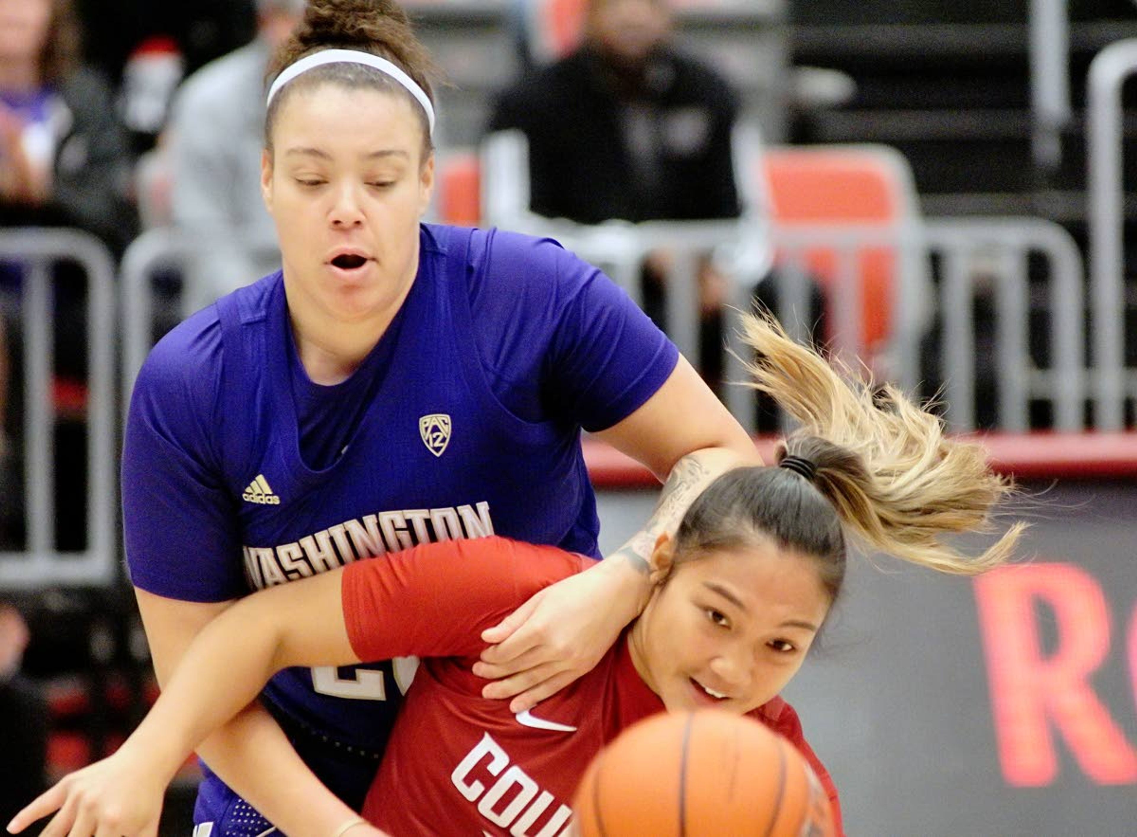 Washington’s Khayla Rooks, left, tries to hold back Washington State guard Cherilyn Molina while chasing down a loose ball in a game Jan. 11 at Beasley Coliseum.