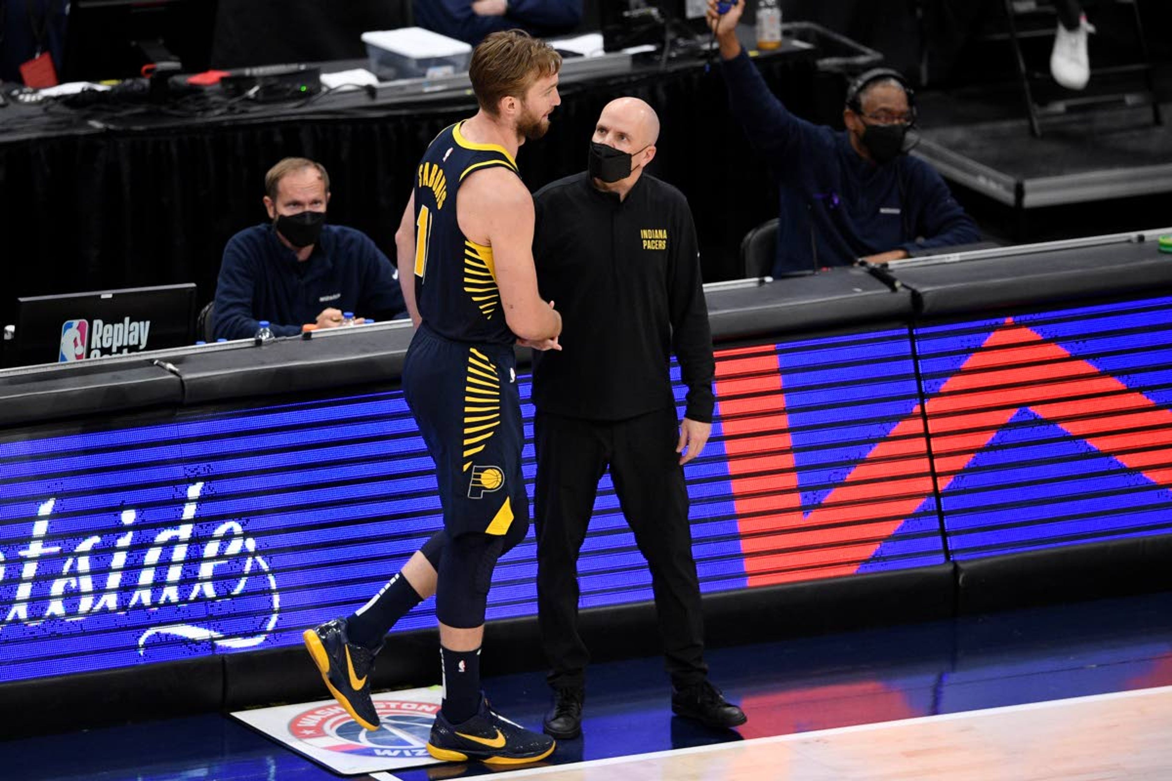 Indiana Pacers forward Domantas Sabonis (11) shakes hands with coach Nate Bjorkgren, right, after fouling out during the second half of the team's NBA basketball Eastern Conference play-in game against the Washington Wizards, Thursday, May 20, 2021, in Washington. (AP Photo/Nick Wass)