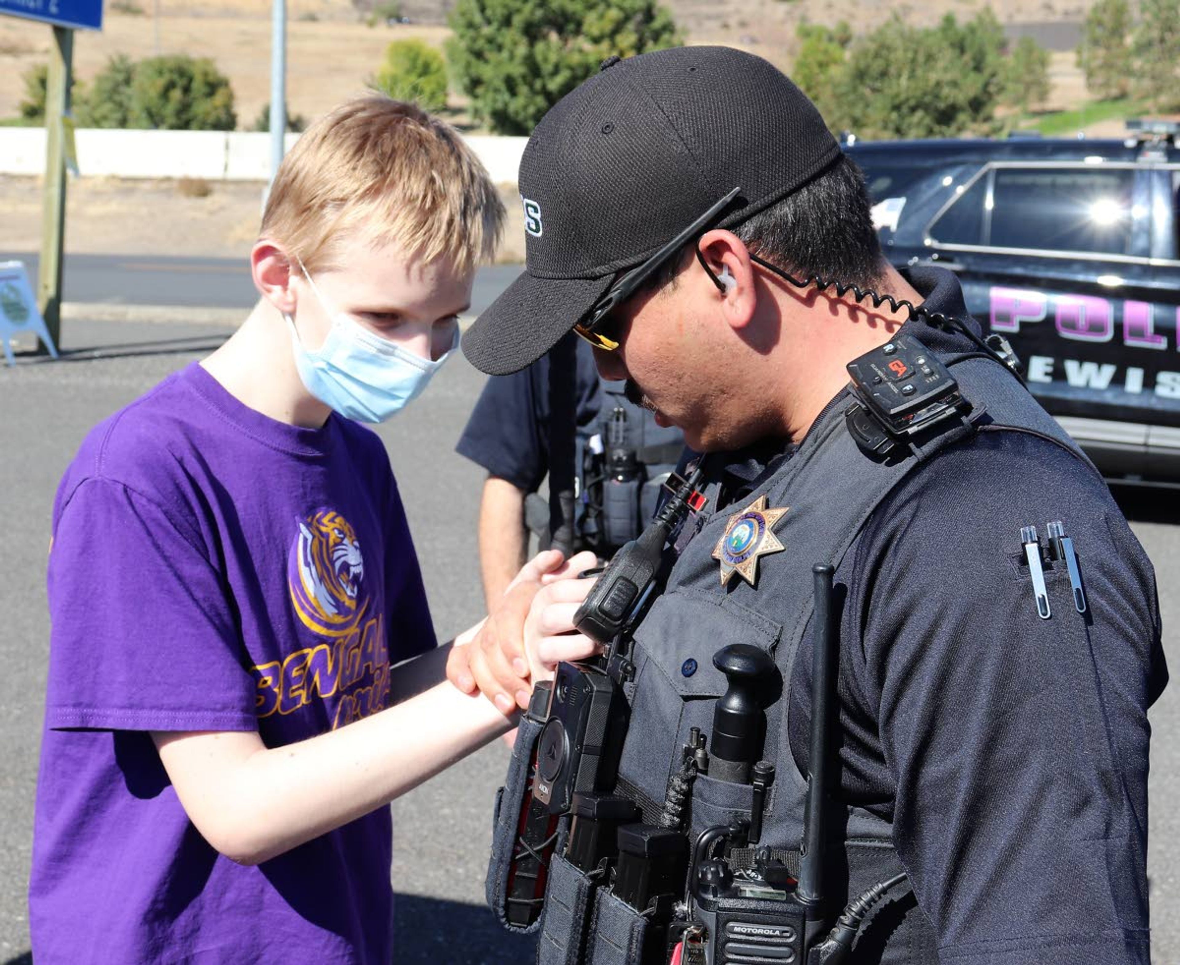 Lewiston Police Officer Chris Smith shows Caleb Hyndman of Lewiston some of the equipment that he carries while on duty. Hyndman, who is blind, participated in a special event hosted by the Idaho State Police in which school age kids who are visually-challenged had the opportunity to touch the equipment carried by officers as well as having the chance to sit in the patrol cars. The event was coordinated by McCall-based Courageous Kids Climbing. Officers who participated in the event also learned how to work with people who are blind. The event took place at the Idaho State Patrol District Office in Lewiston on Saturday. The photo was taken by Jeff Riechmann of Courageous Kids Climbing.