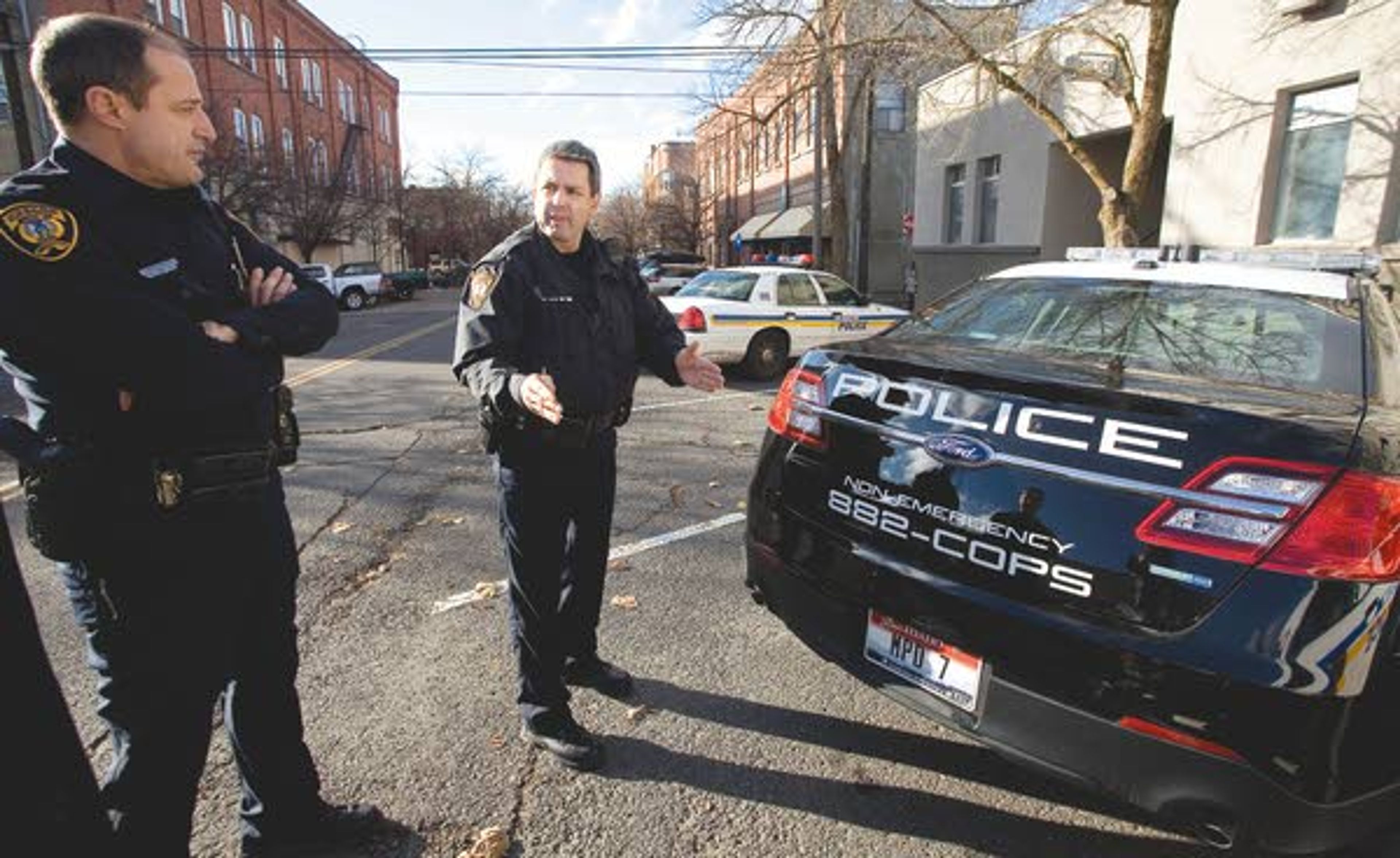 Lt. Paul Kwiatkowski, center, and patrol officer J.P. Knickerbocker look one of the new black-and-white painted Ford Taurus all-whel drive intercepters bought by the Moscow Police Department on Thursday.