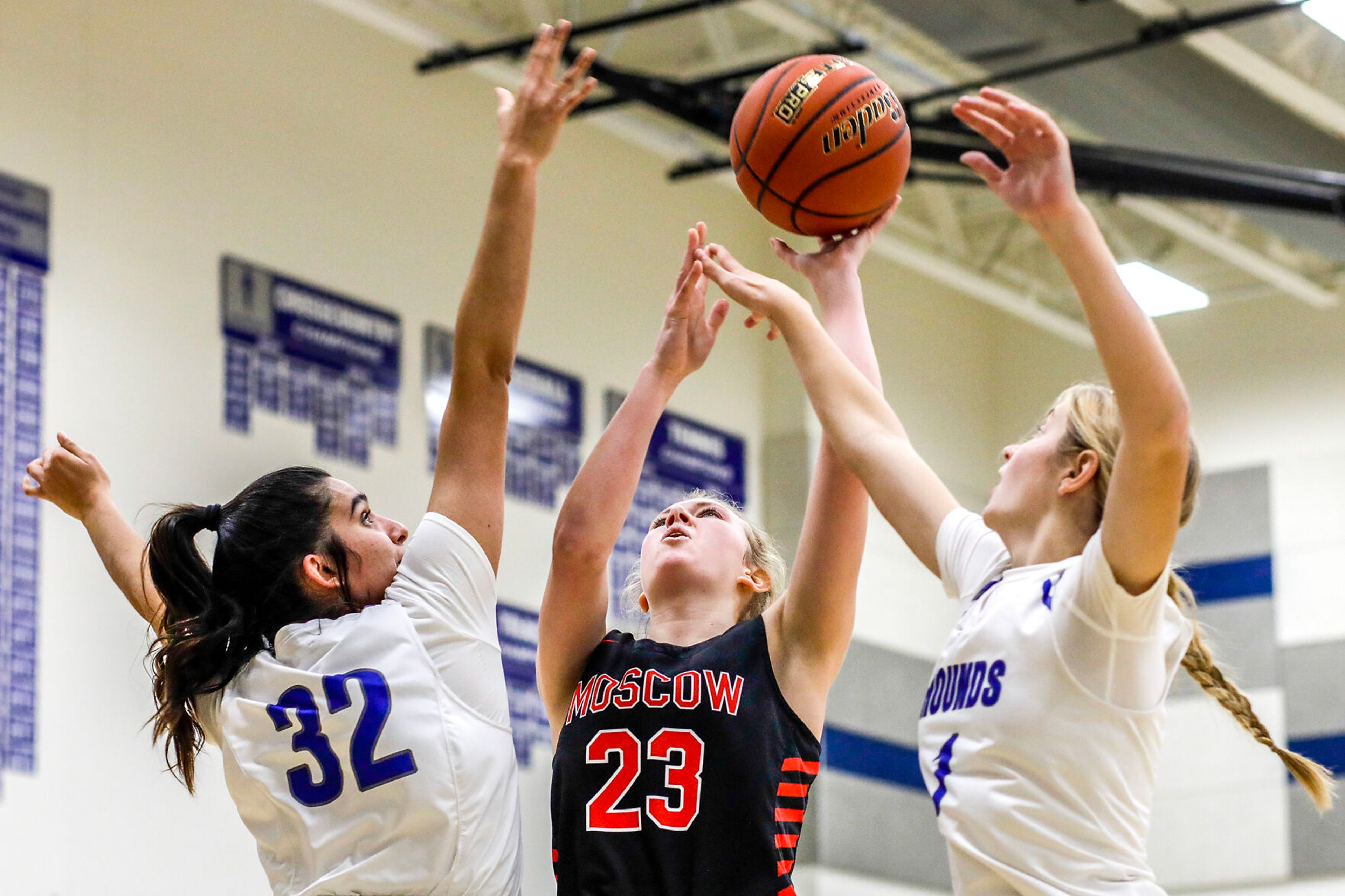 Moscow forward Jessa Skinner, center, shoots the ball as Pullman post Sehra Singh, left, and guard Megan Limburg defend during Saturday’s nonleague girls basketball game.