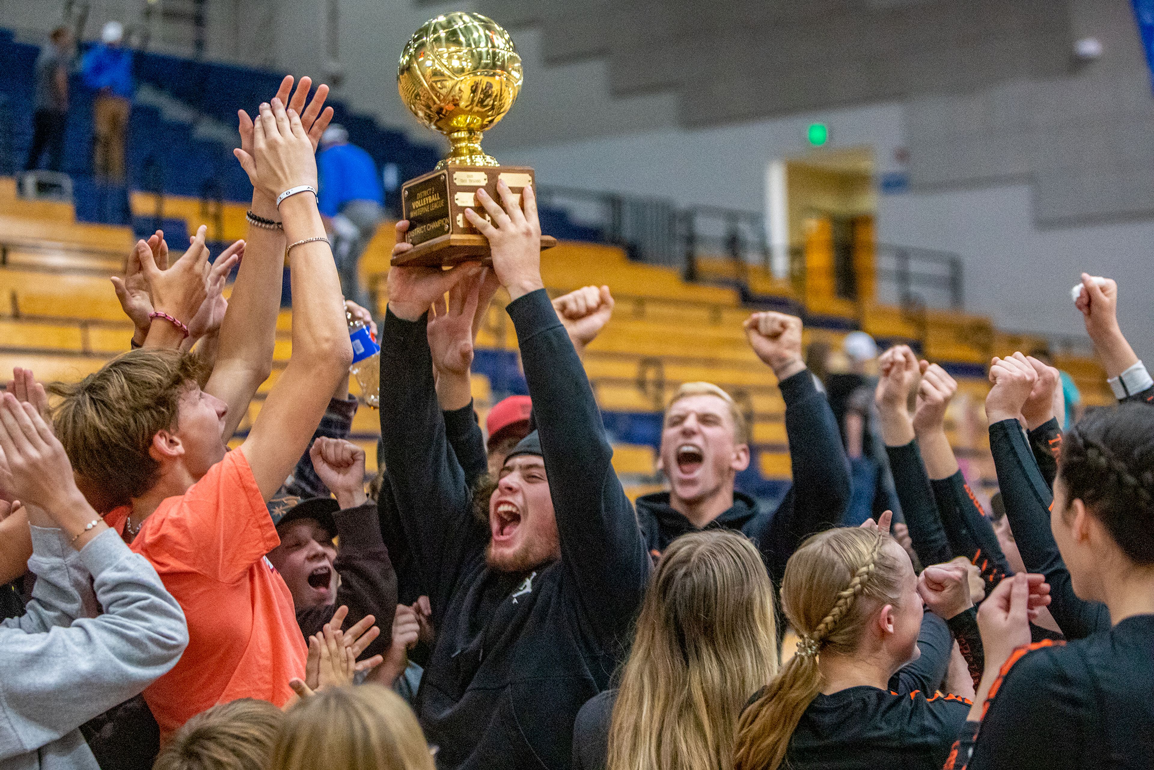 Troy High students celebrate their teams win over Genesee in the Idaho Class 1A Division I district volleyball tournament at the P1FCU Activity Center in Lewiston on Wednesday.