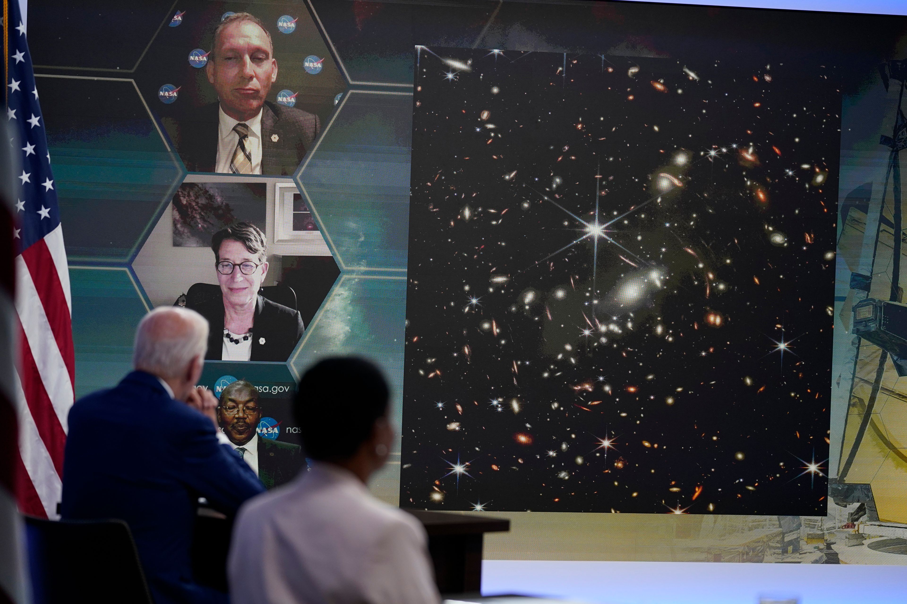 President Joe Biden listens during a briefing from NASA officials about the first images from the Webb Space Telescope, the highest-resolution images of the infrared universe ever captured, in the South Court Auditorium on the White House complex, Monday, July 11, 2022, in Washington. On screen are NASA Associate Administrator for the Science Mission Directorate Thomas Zurbuchen, top, Deputy Director of the Space Telescope Science Institute (STScI) Nancy Levenson, and NASA James Webb Space Telescope Program Director Greg Robinson, bottom. (AP Photo/Evan Vucci)