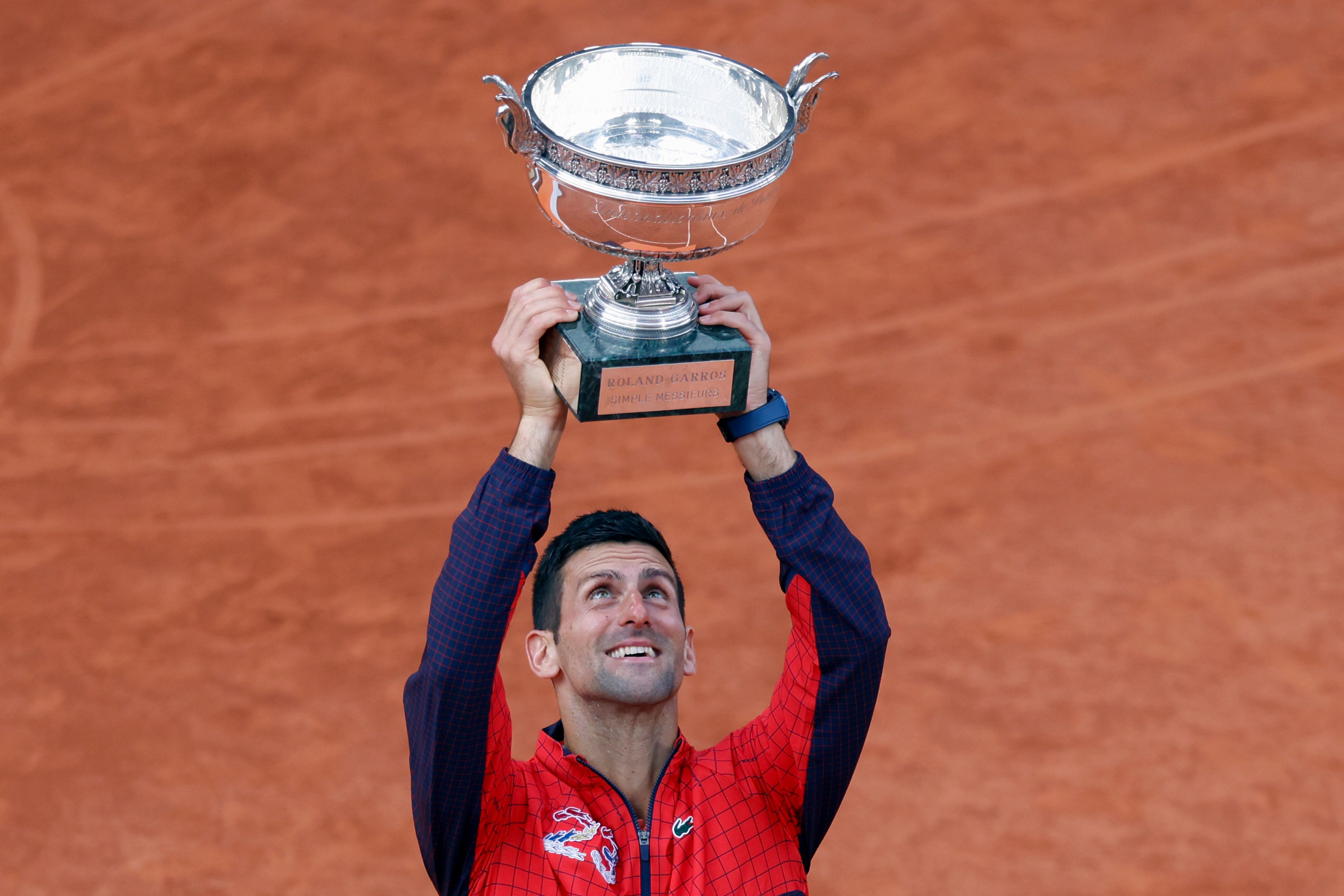 Serbia's Novak Djokovic holds the trophy as he celebrates winning the men's singles final match of the French Open tennis tournament against Norway's Casper Ruud in three sets, 7-6, (7-1), 6-3, 7-5, at the Roland Garros stadium in Paris, Sunday, June 11, 2023. (AP Photo/Jean-Francois Badias)