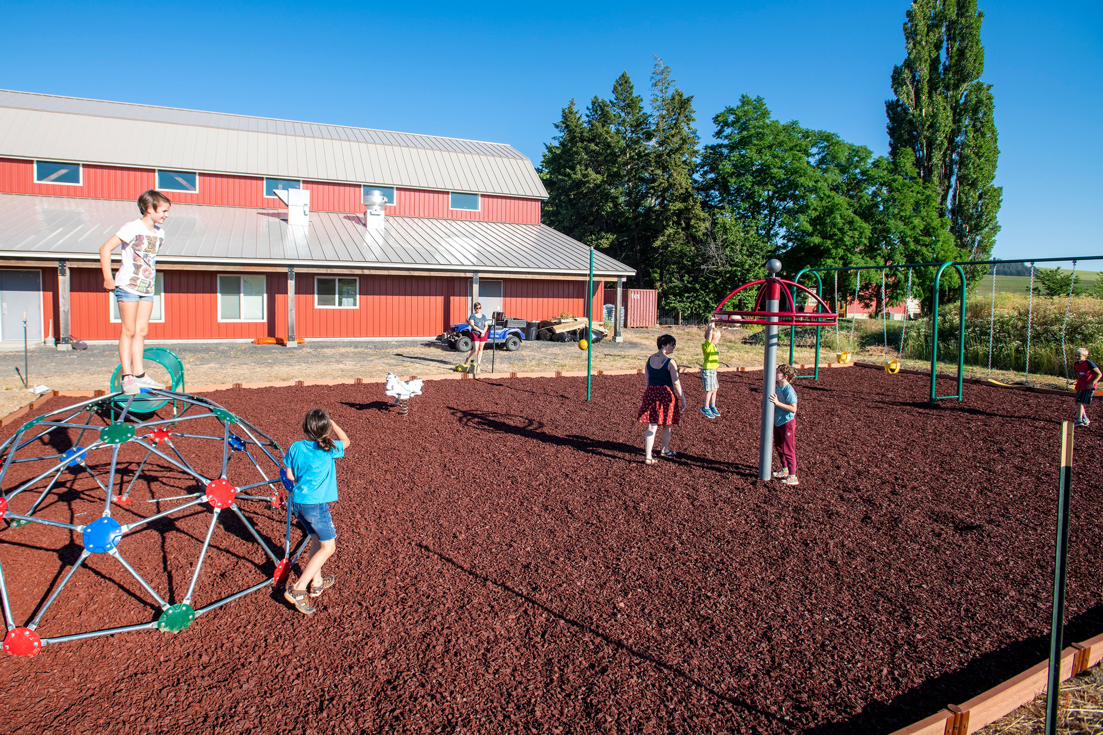 Children play on the Viola Community Center playground, recently completed through donations, grants and volunteer work.