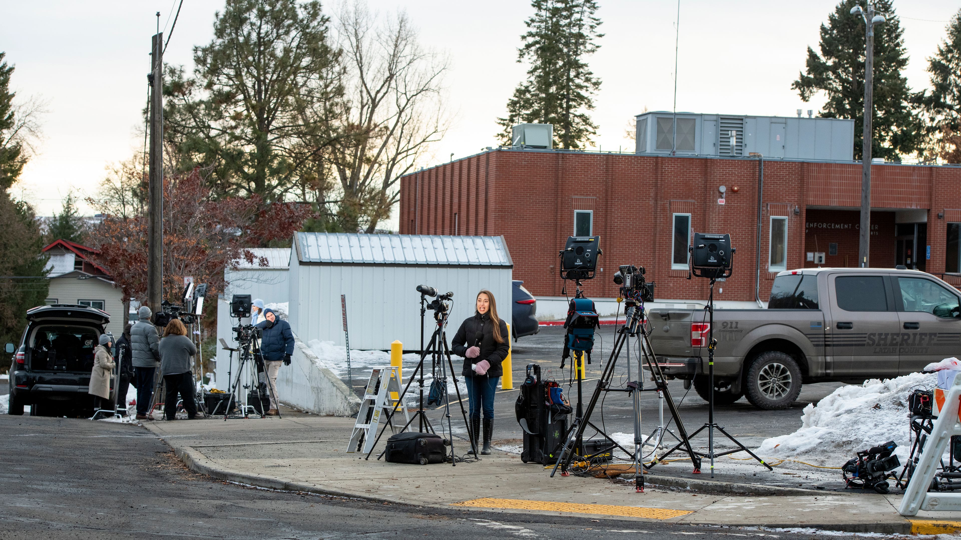 Media members setup cameras outside of the Latah County Jail as they wait for the arrival of Bryan Kohberger in Moscow on Wednesday. Kohberger is a suspect in a quadruple homicide case involving four University of Idaho students from Nov. 13.