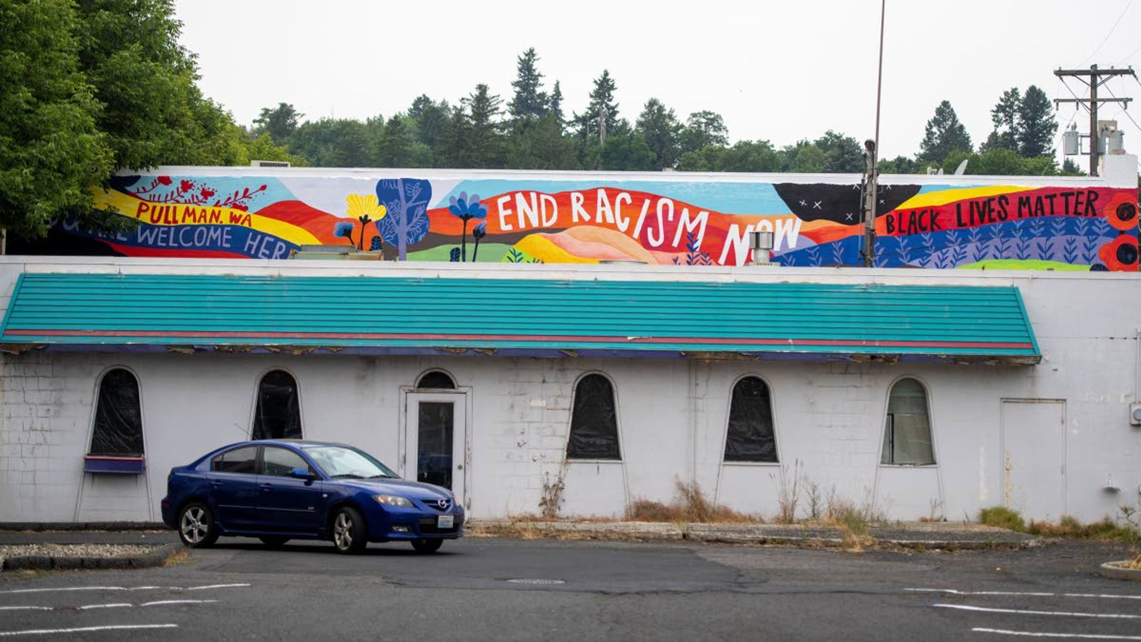 Zach Wilkinson/Daily NewsA vehicle drives through an empty parking lot beneath artist Jiemei Lin’s “End Racism Now” mural along Main Street in Pullman on Monday morning.