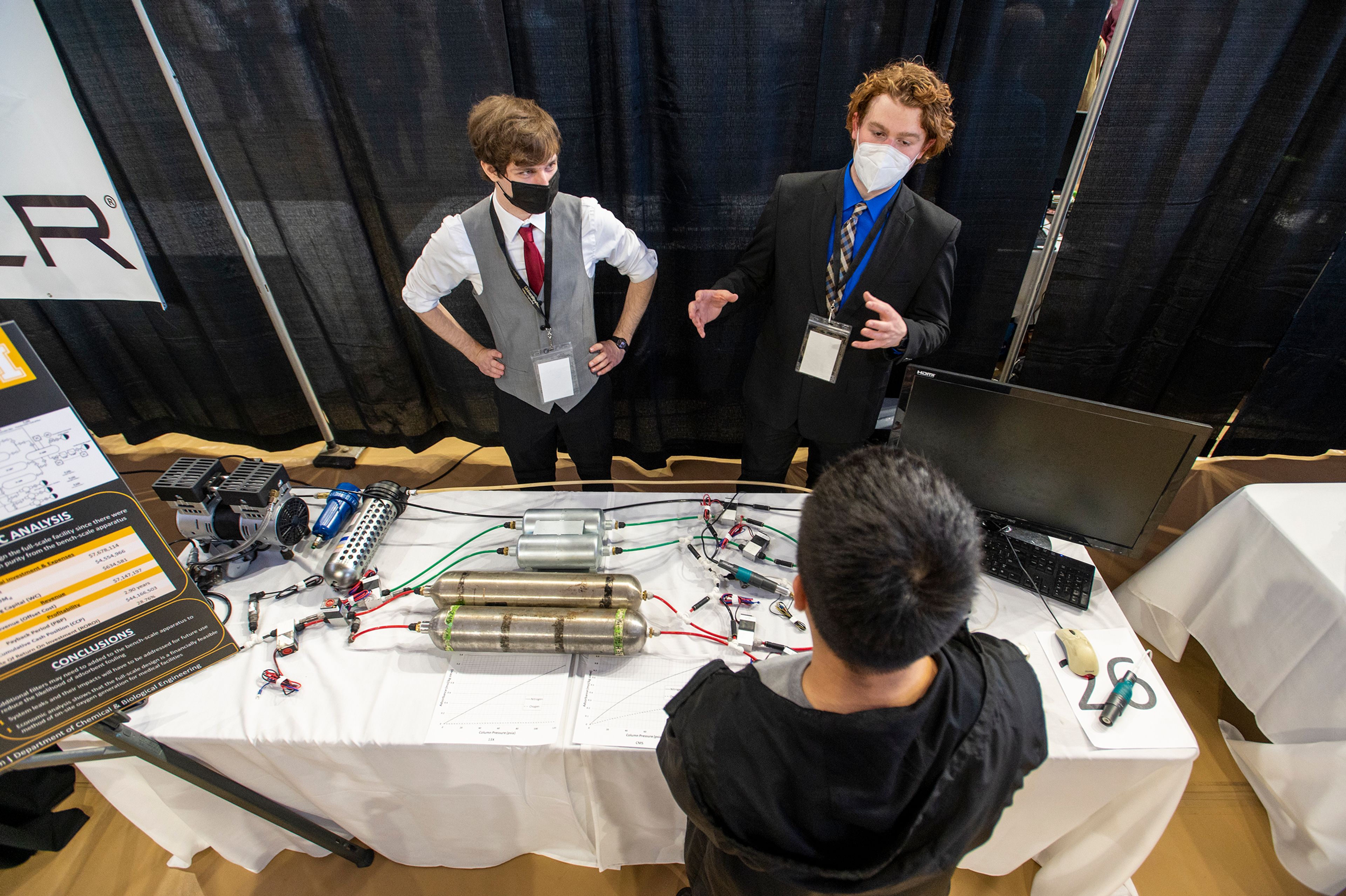 Matthew Pyle, left, and Kelty Shroyer explain the functions of their PSA Apparatus, which is meant to generate on-site oxygen at a much more affordable cost to hospitals.