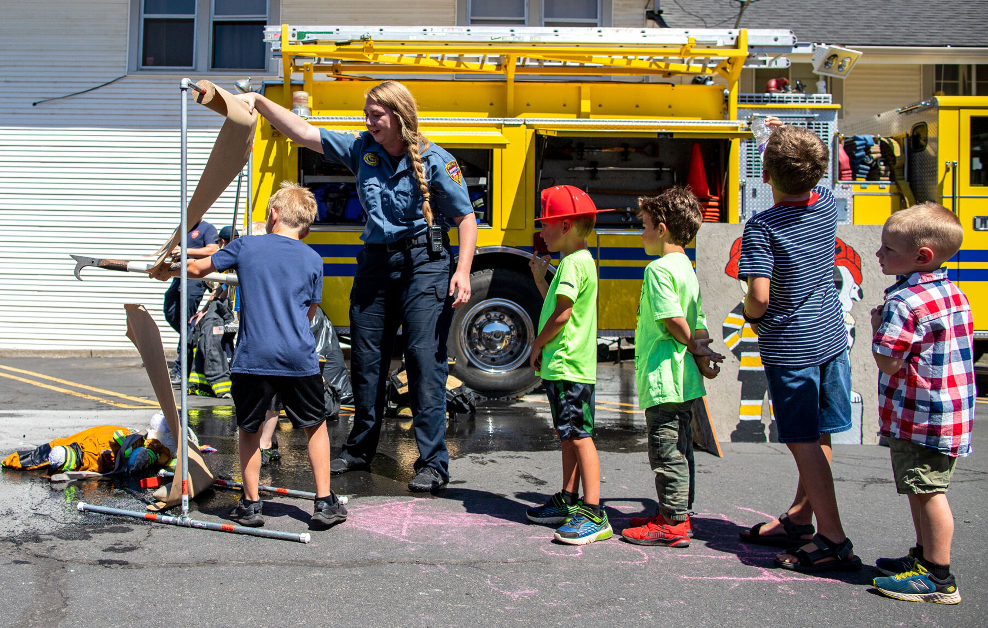 Kids line up to participate in some mock fire drills to win prizes Saturday during the city of Colfax’s 150th birthday celebration.