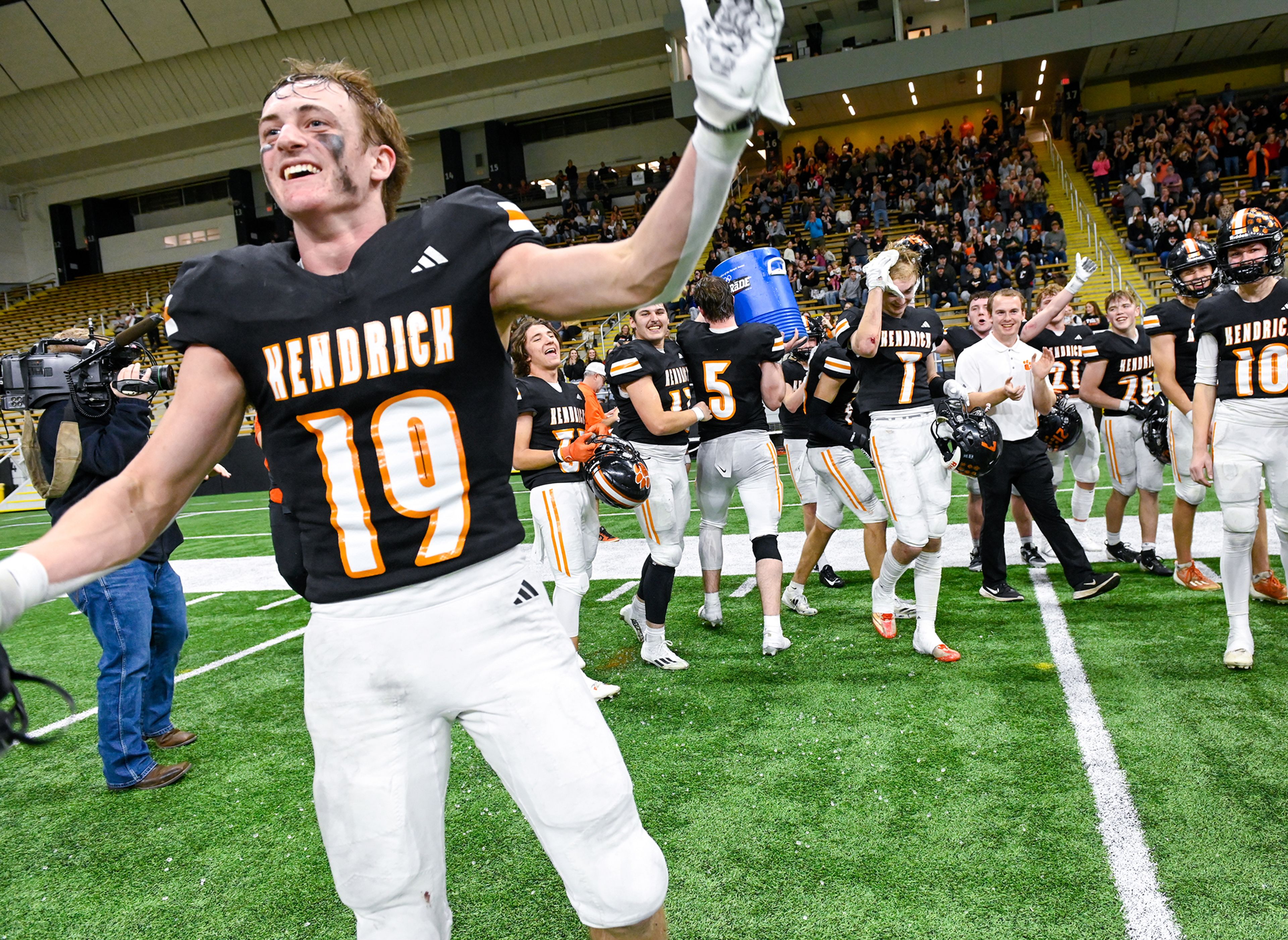 Kendrick players and coaches, including Saywer Hewett, front, celebrate their Idaho Class 2A state championship win over Butte County at the P1FCU Kibbie Dome in Moscow.