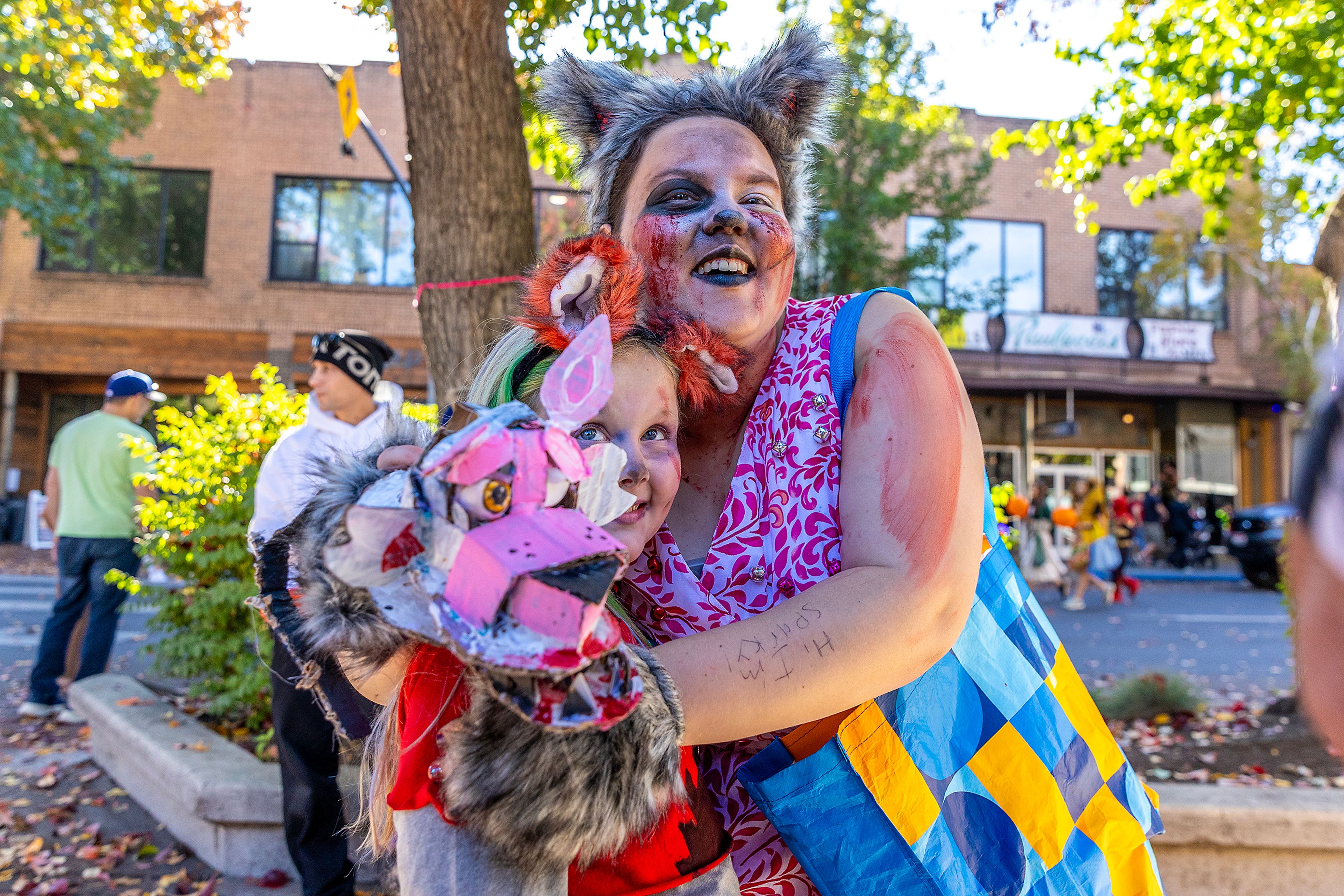 Rhyanne Wiggins, dressed as sparky the dog from Five Nights at Freddy�s, hugs Charlie Hartel, 8, dressed as Roxxane, Saturday at Pumpkin Palooza in downtown Lewiston.,