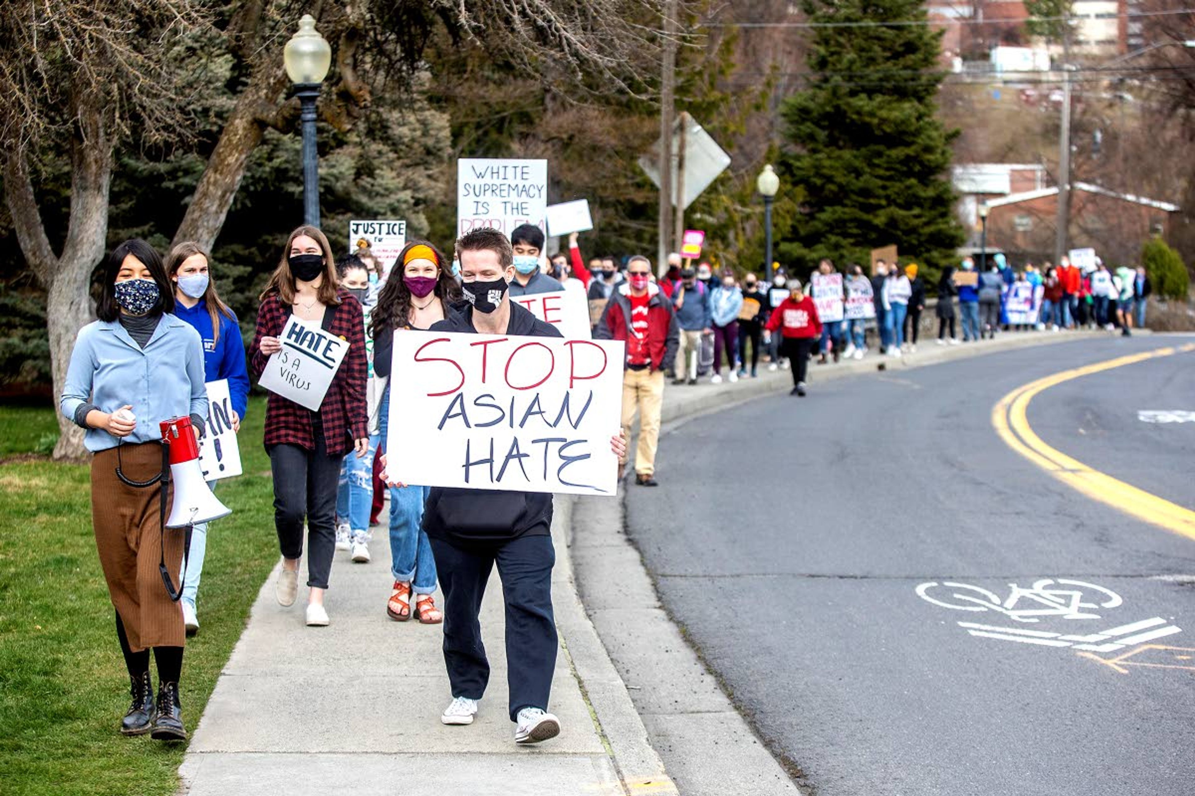 About 80 people march down the street after the conclusion of the speeches at the “Stop AAPI Hate on the Palouse” rally in Pullman on Saturday.