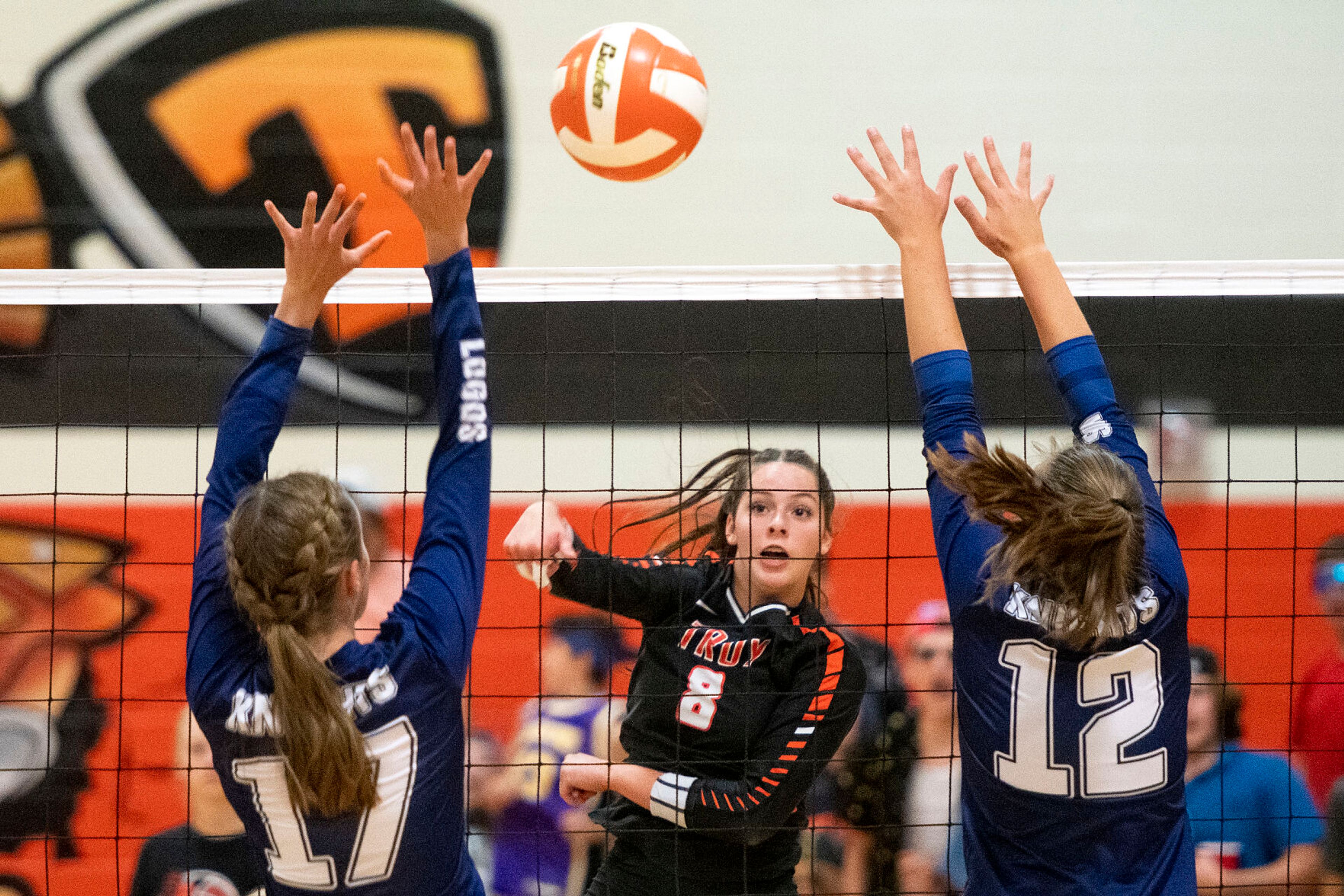 Troy’s Jolee Ecklund, center, hits the ball during a Sept. 20 Whitepine League Division I match against Logos. Ecklund had 11 kills in the Trojans’ three-set win Saturday against Clearwater Valley of Kooskia in the Idaho Class 1A Division I district tournament at Lewis-Clark State College’s P1FCU Activity Center.