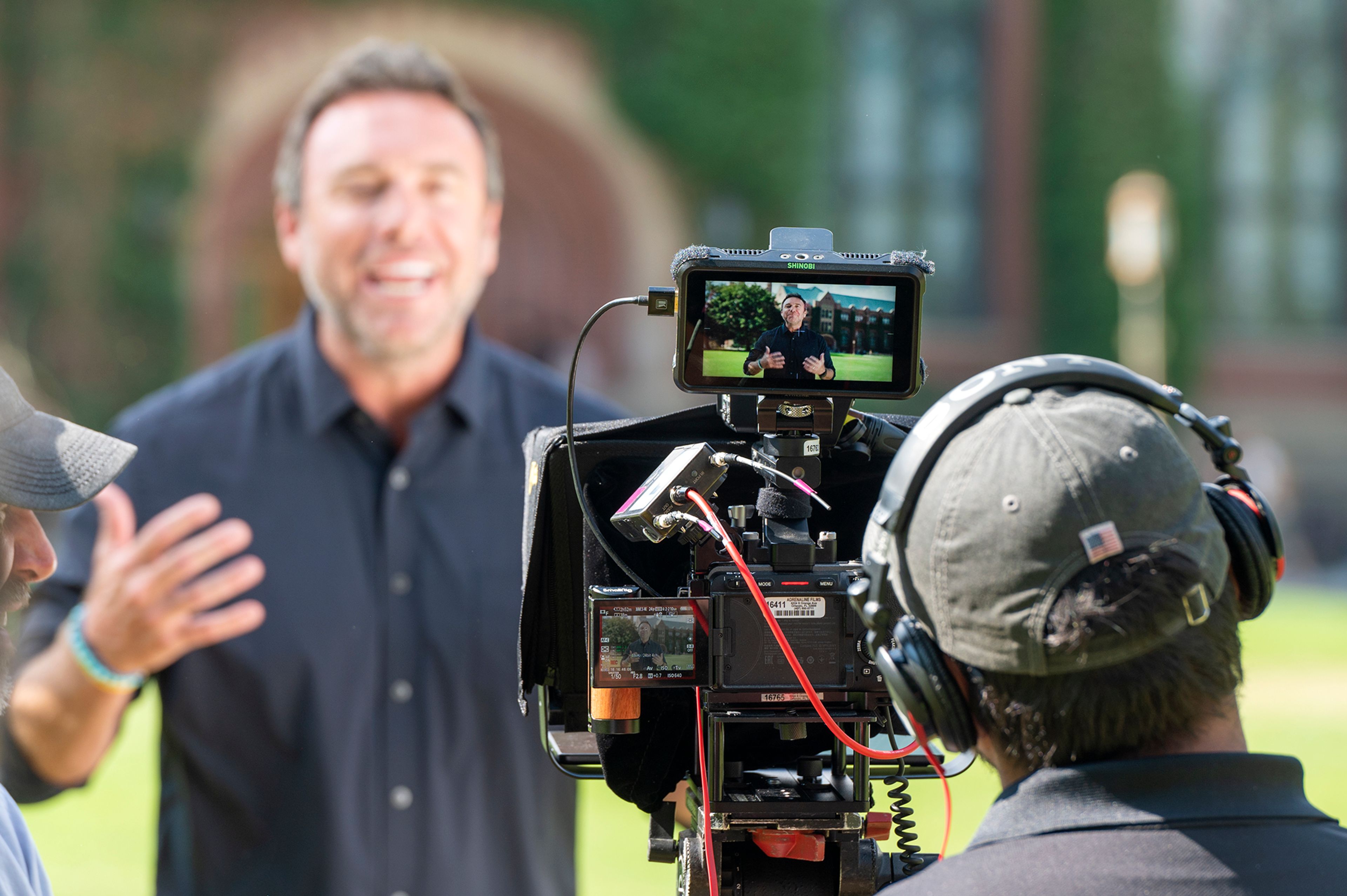 Alex Boylan, host and co-creator of "The College Tour," films a segment of the show Friday in front of the Administration Building on University of Idaho’s campus in Moscow.