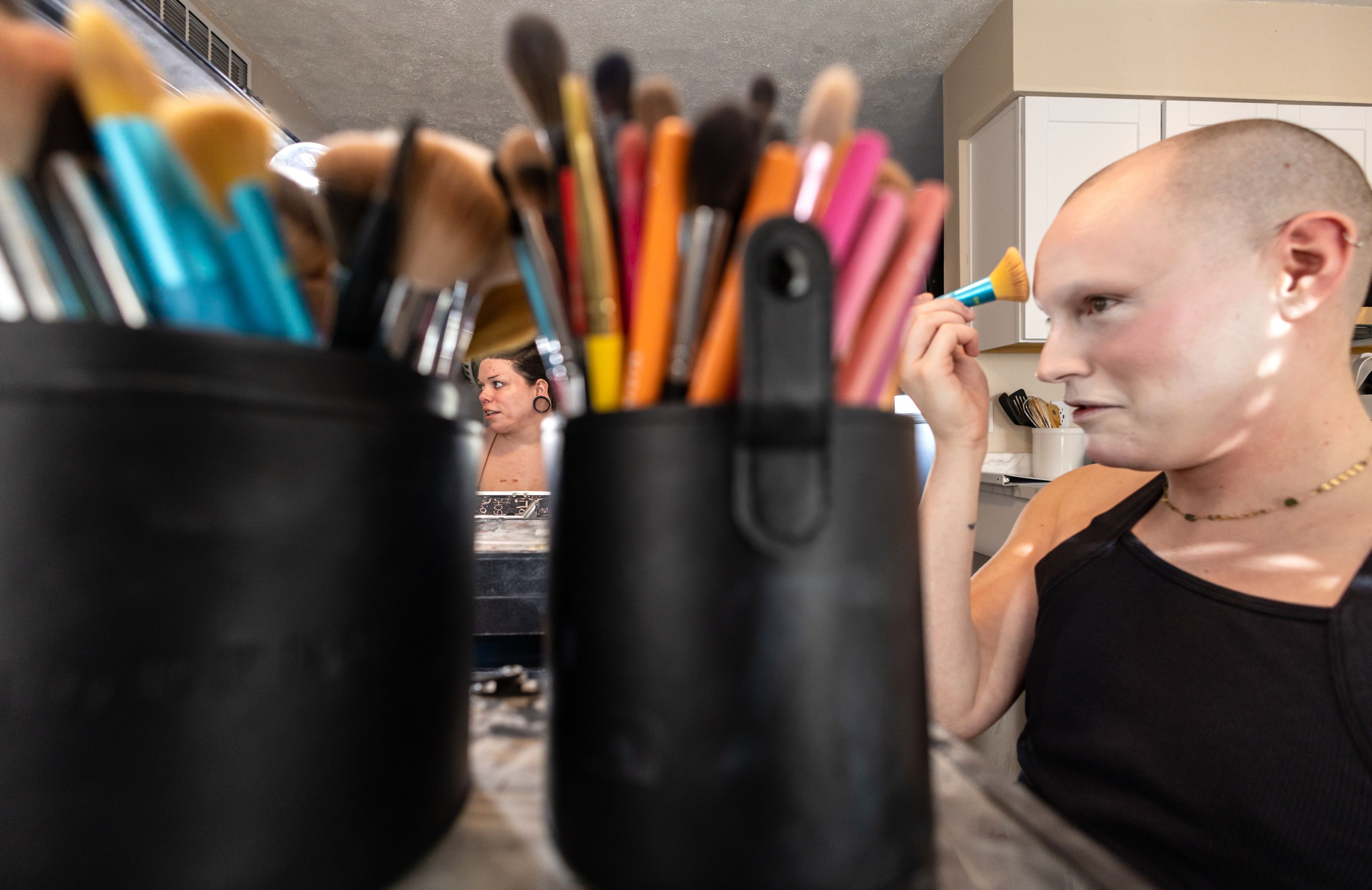 Wabaunsee, center, and fellow queen Vicky D. Boulevard put on their makeup at their AirBnB in Clarkston on March 14 a few hours before their first night of performances at the Boomtown Saloon.