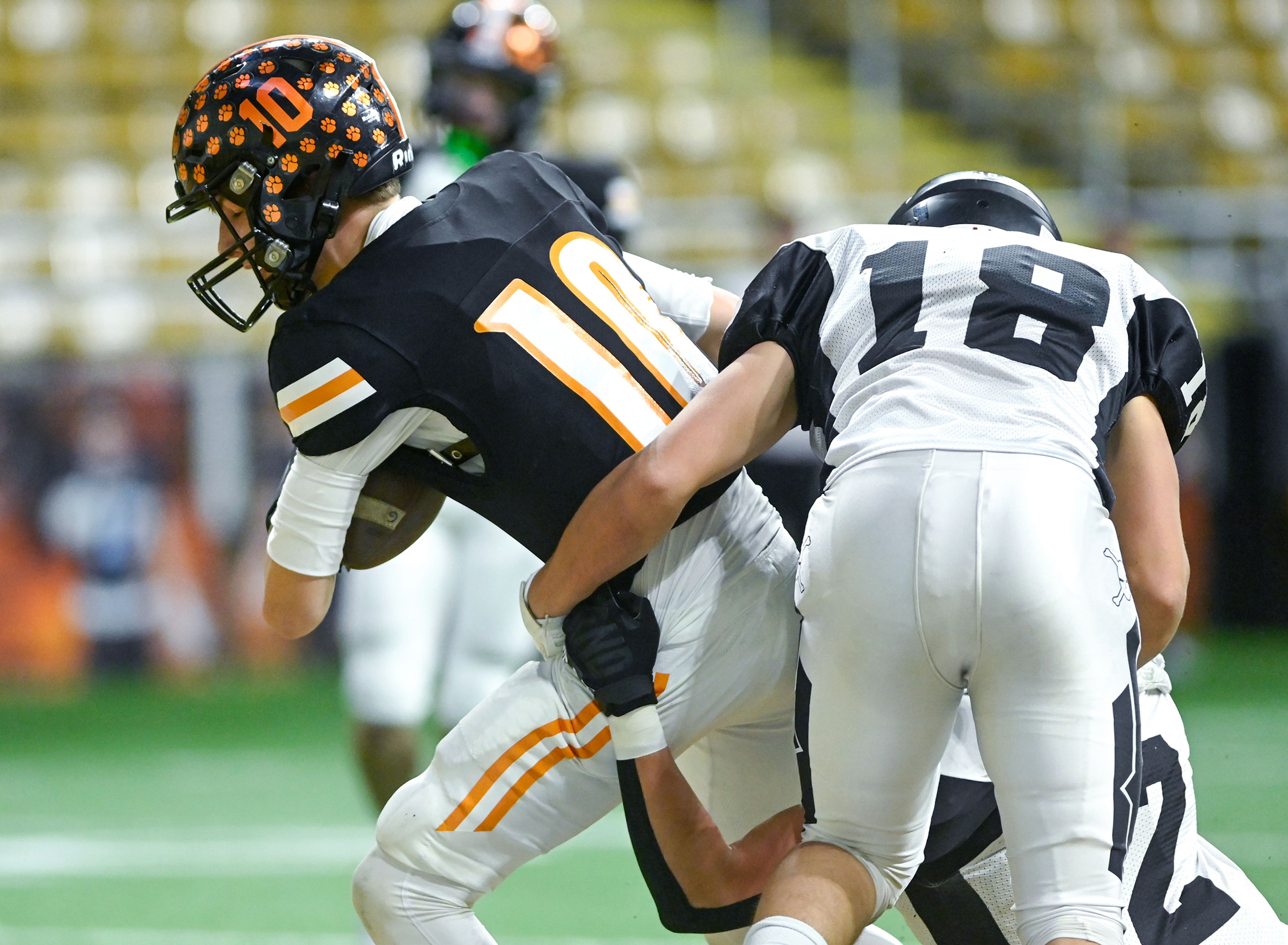 Kendrick’s Maddox Kirkland pushes against Butte County defenders to land a two-point conversion Friday during the Idaho 2A football state championship game at the P1FCU Kibbie Dome in Moscow.