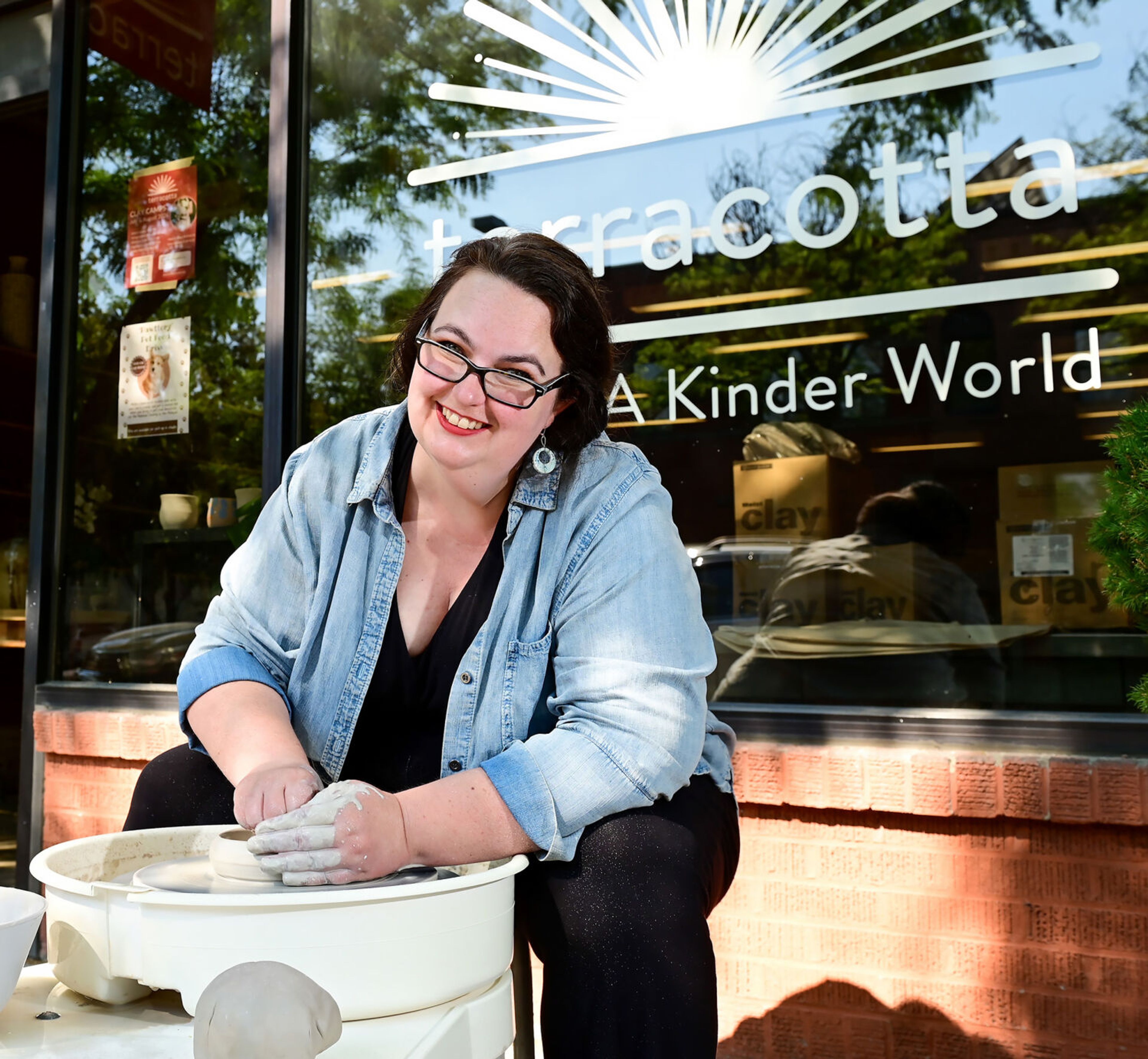 Owner and founder Candace Baltz sits at a potter's wheel outside of Terracotta’s new downtown Moscow space on Wednesday.