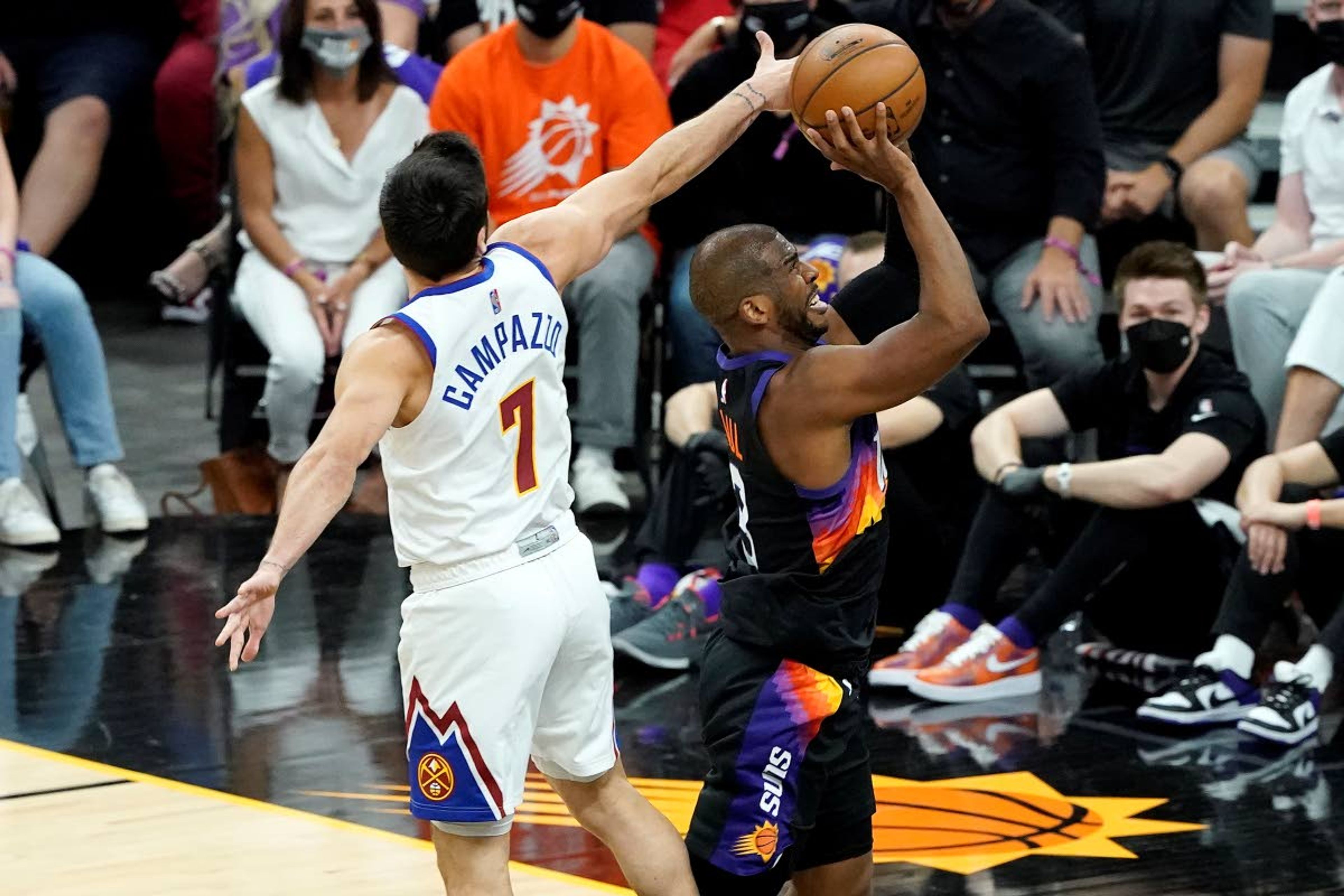 Phoenix Suns guard Chris Paul shoots as Denver Nuggets guard Facundo Campazzo (7) defends during the first half of Game 2 of an NBA basketball second-round playoff series, Wednesday, June 9, 2021, in Phoenix. (AP Photo/Matt York)