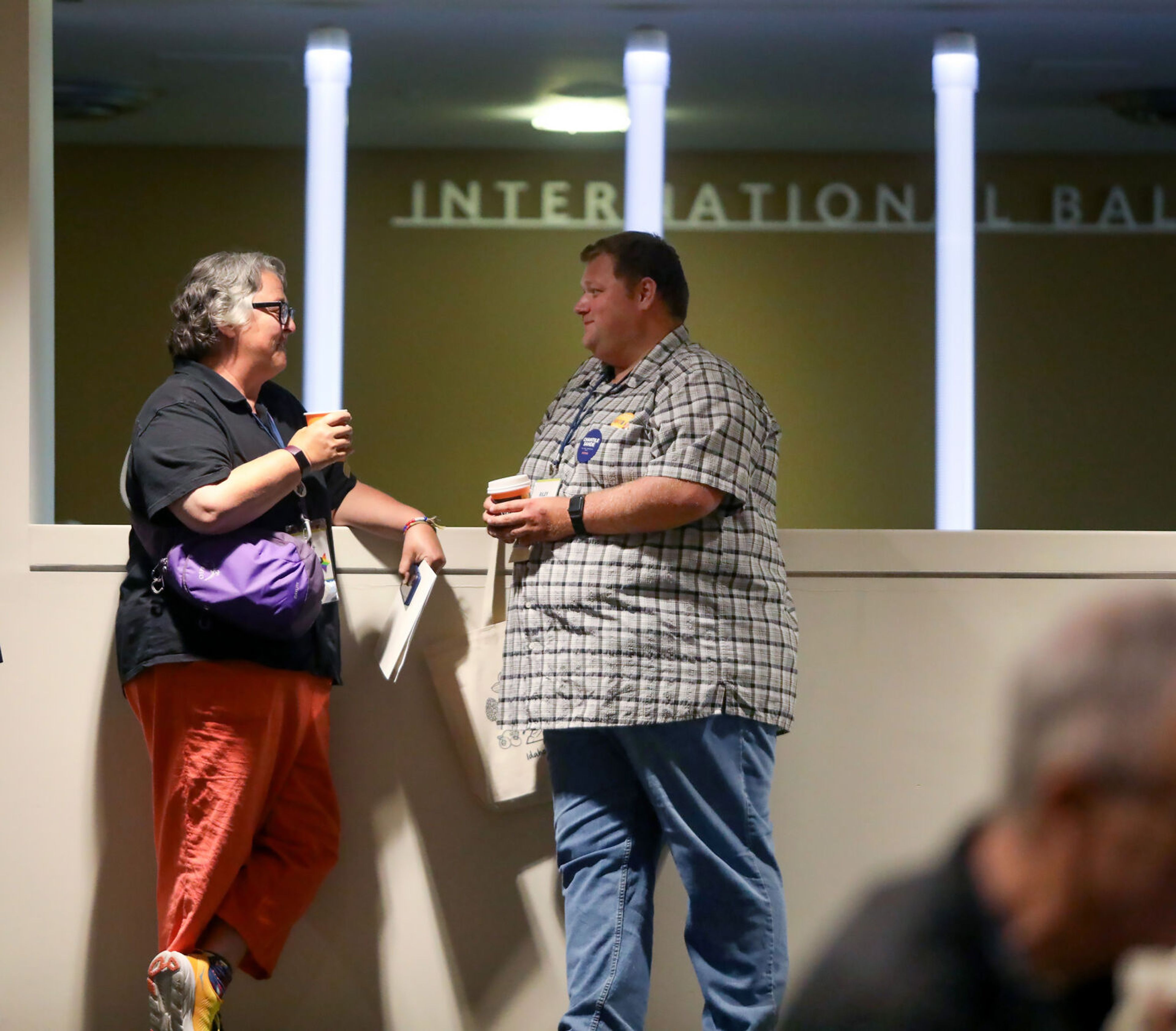 Moscow City Council member Sandra Kelly, left, speaks with Riley Reintjes, of Latah County, between sessions at the Idaho Democratic Convention on Saturday in Moscow.