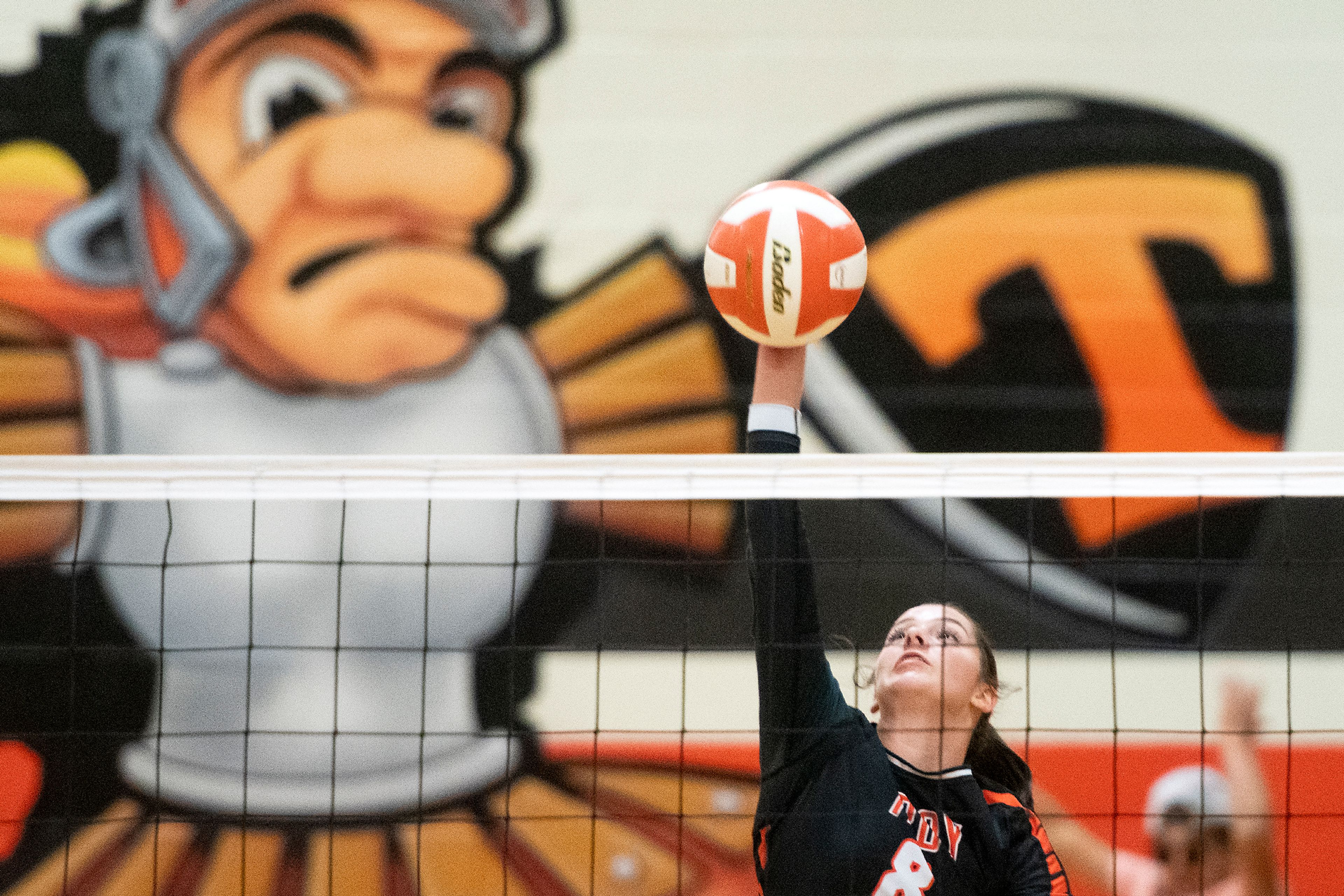 Troy’s Jolee Ecklund (8) spikes the ball during a Whitepine League matchup against Logos at Troy High School.