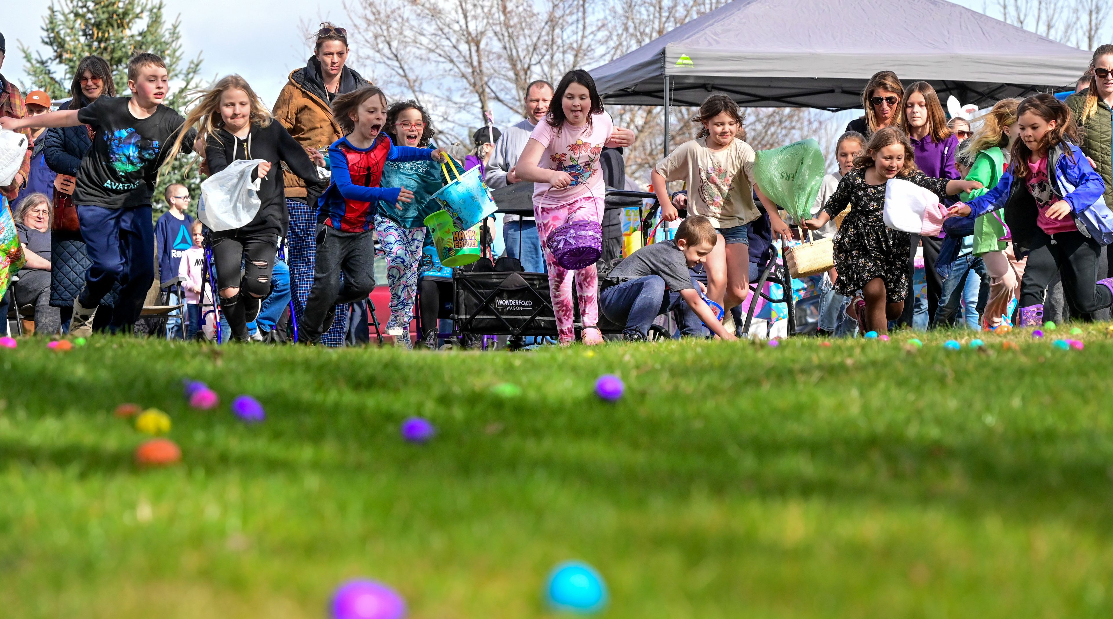 Kids begin to race toward Easter eggs scattered across Aspen Park of Cascadia in Moscow on Friday. Over 5000 eggs were hidden across the hillside and back patio, with special golden eggs for extra prizes mixed in.